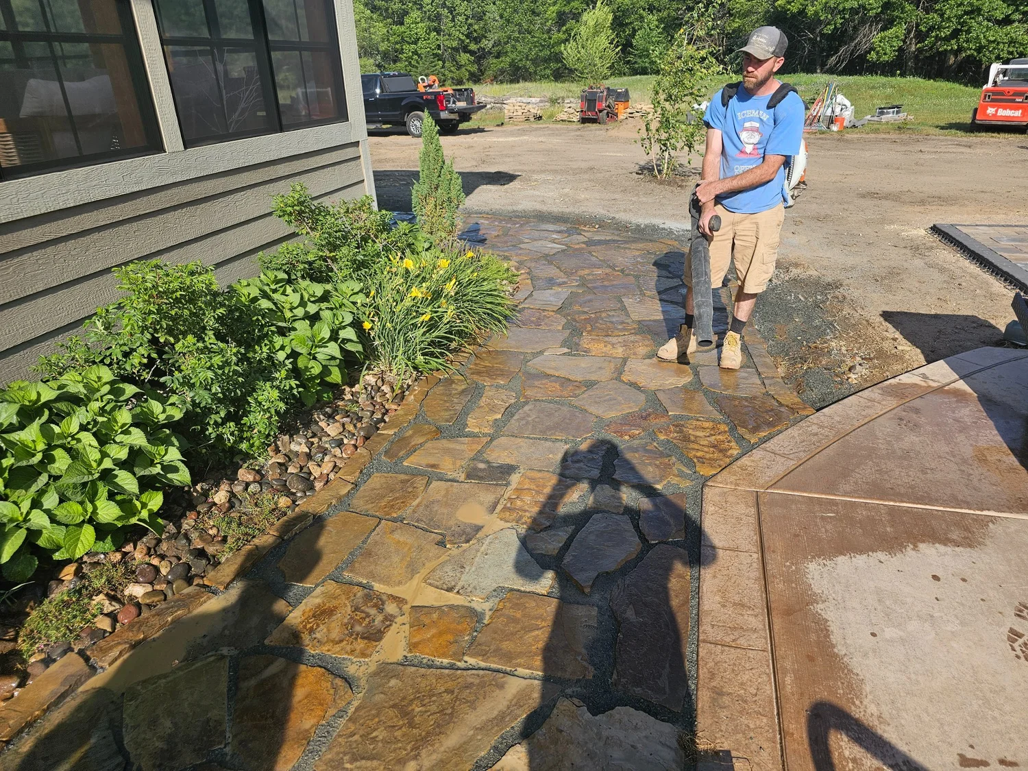 Crew finishing natural stone walkway — West Lakeland Township MN — Heritage Outdoors 2023