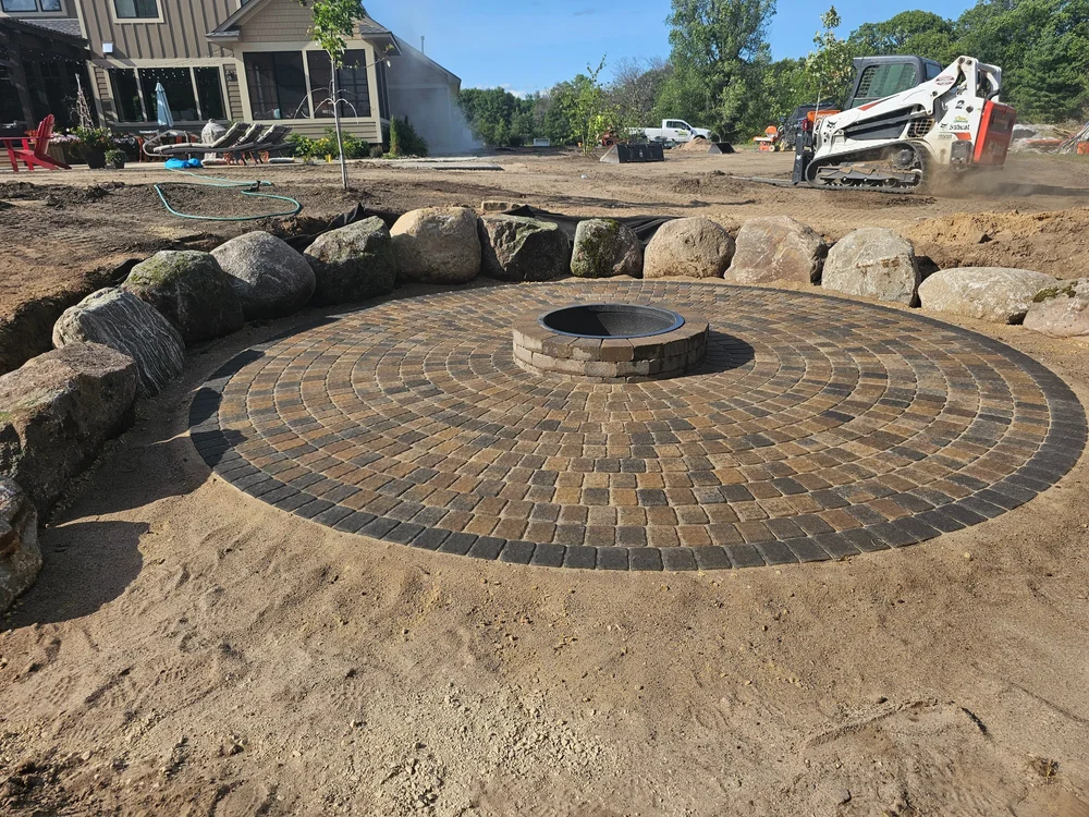 Boulder wall and paver circle firepit — Mahtomedi MN — Heritage Outdoors