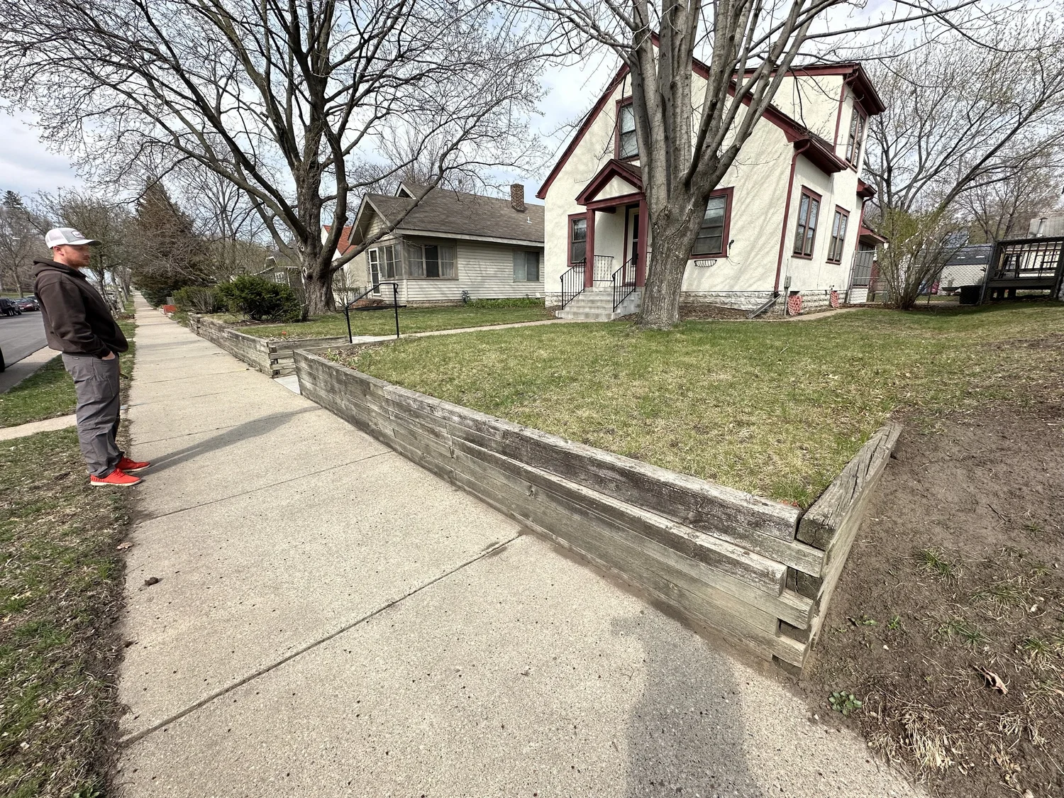 Rotting timber retaining wall during site visit — Jacob assessing — Minnehaha Minneapolis MN — Heritage Outdoors 2024