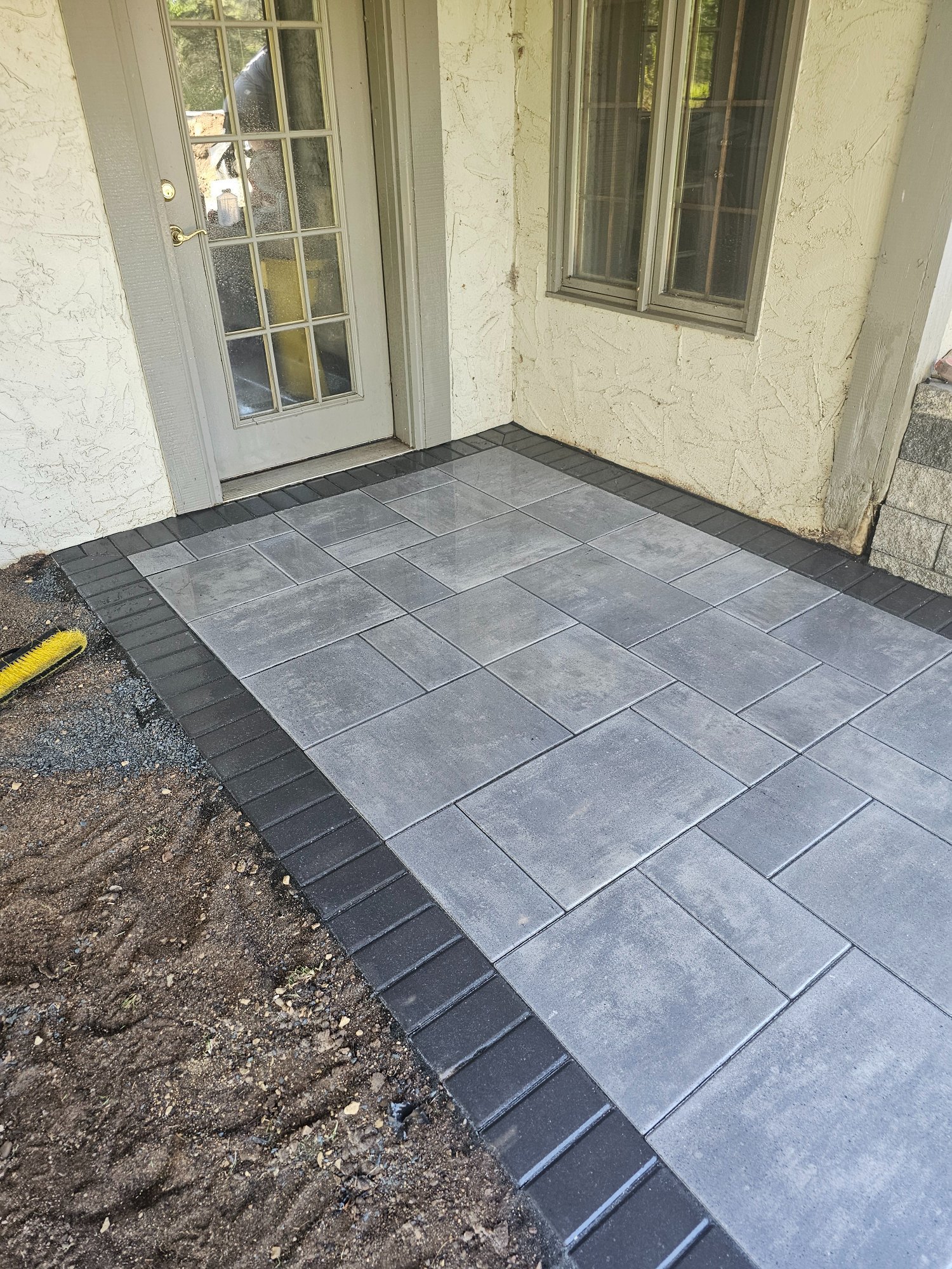 Finished paver walkway at back door with Holland Premier Dark Charcoal border — Lake Elmo MN — Heritage Outdoors