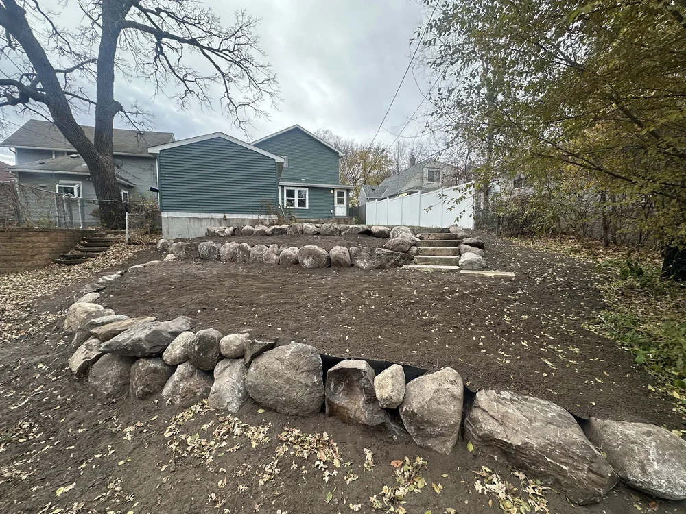 Tiered boulder wall and natural stone steps — Saint Anthony Park Saint Paul MN — Heritage Outdoors 2025