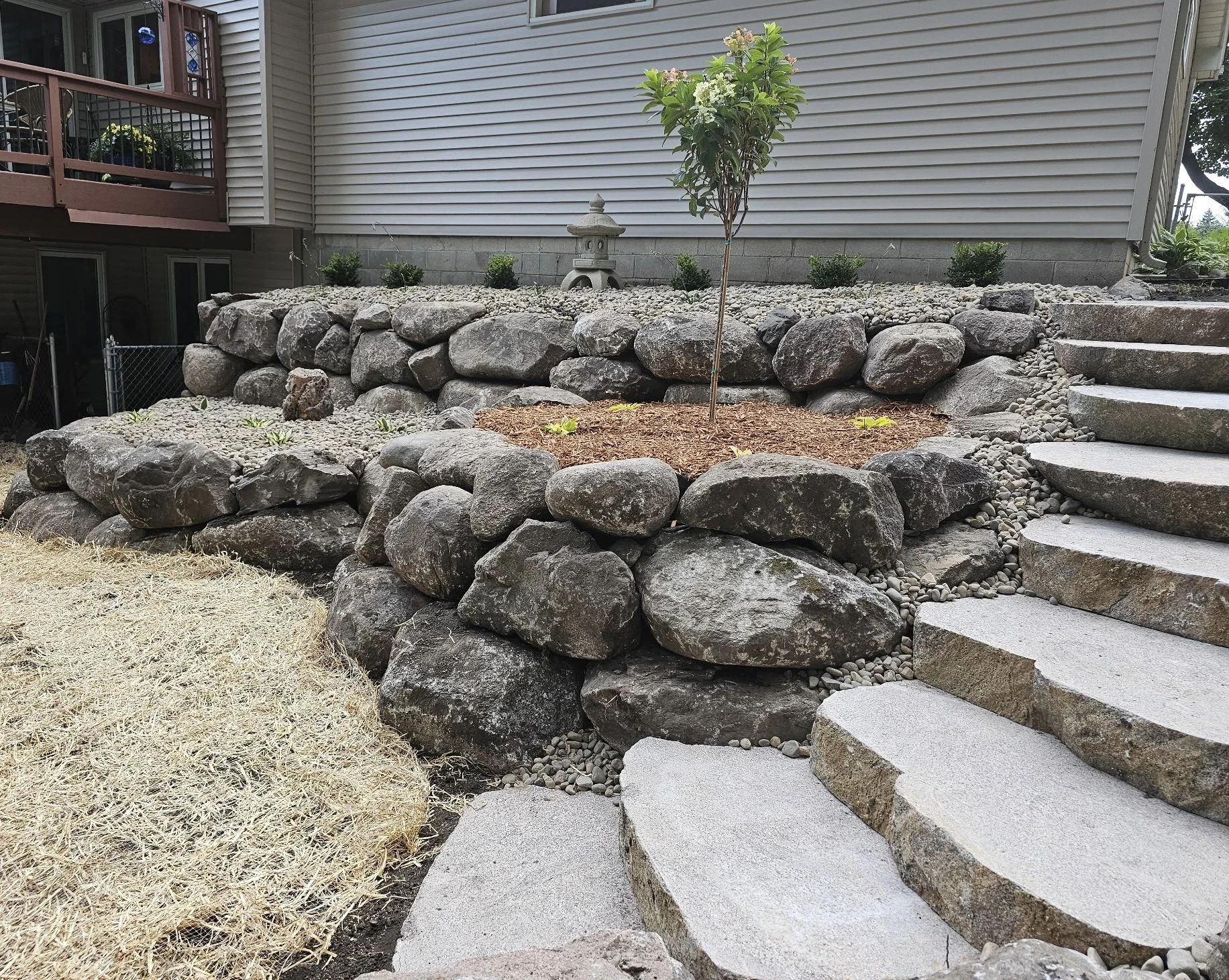Natural boulder retaining wall installed in Woodbury MN by Heritage Outdoors