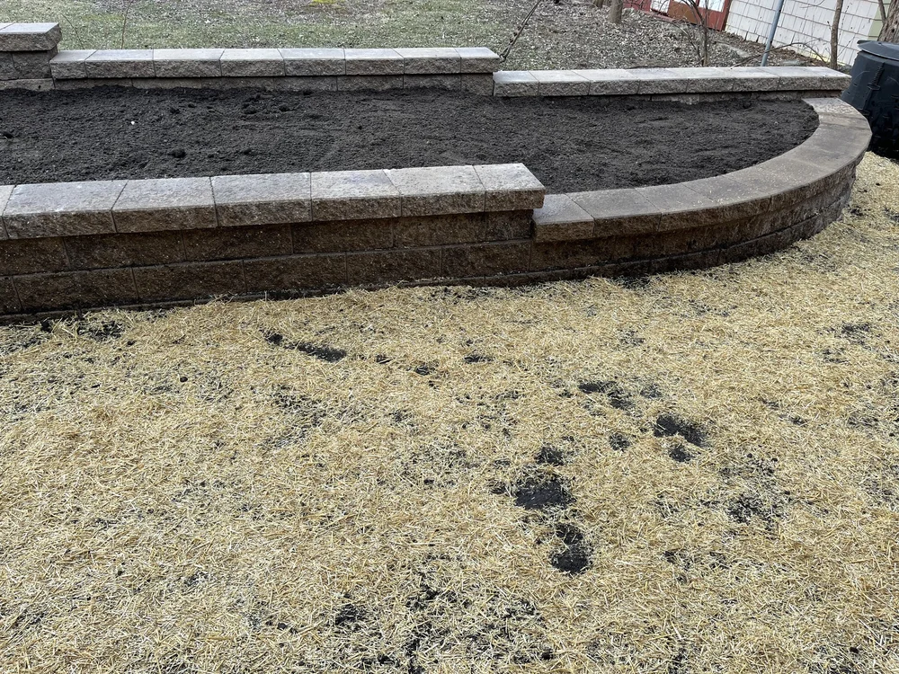 Completed Versa-Lok tan curved planter boxes — Stillwater MN — Heritage Outdoors 2025