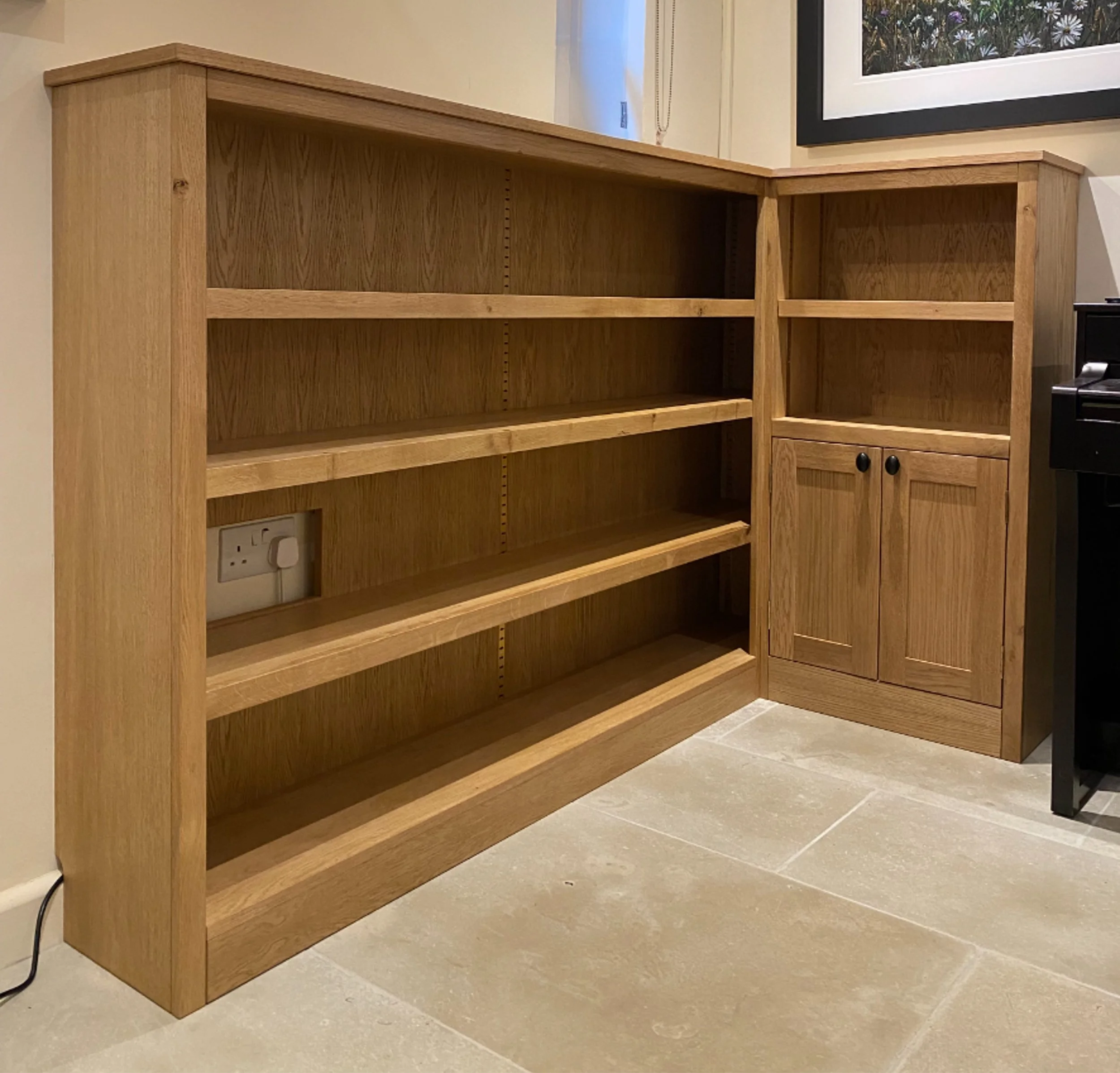 Oak bookcase with inlaid brass shelf studs and rails for the three adjustable shelves