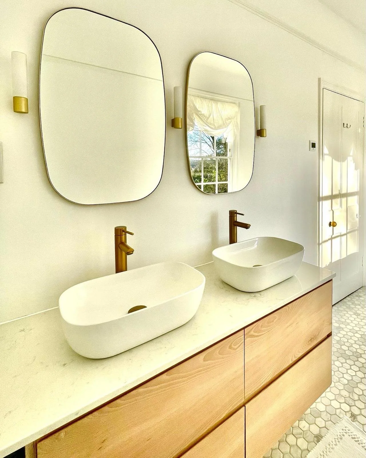 Beech bathroom double basin vanity unit with two drawers. Modern design with modern windows and brass taps and light fittings