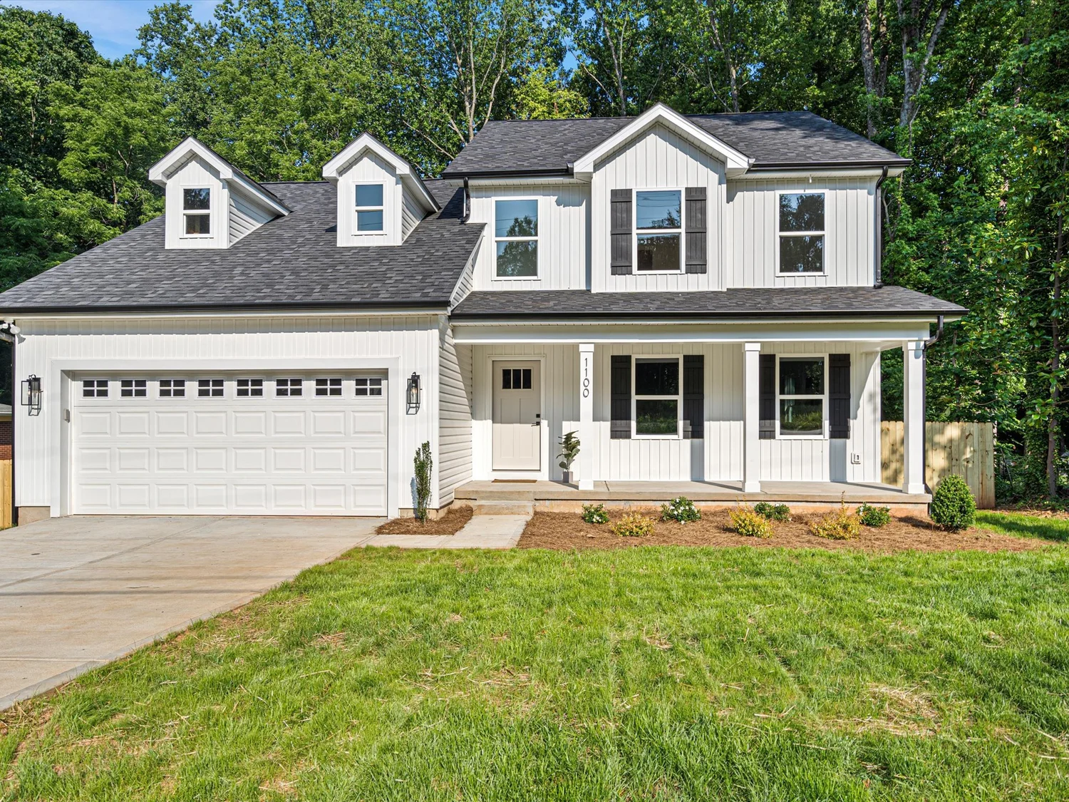Completed Antioch Building Group home with a lawn and tree-lined surroundings
