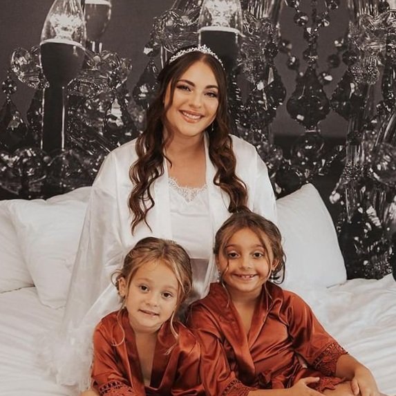 A bride and two children getting ready for the big day with glam makeup.