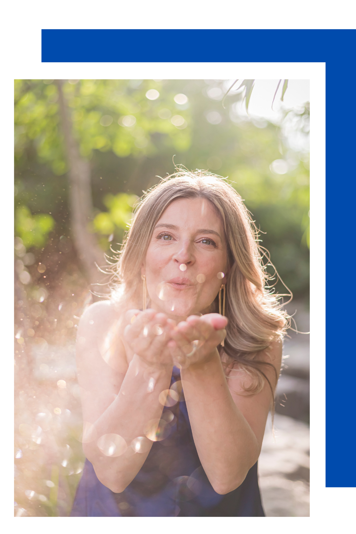 Woman blowing glitter or sparkles outdoors in sunlight.