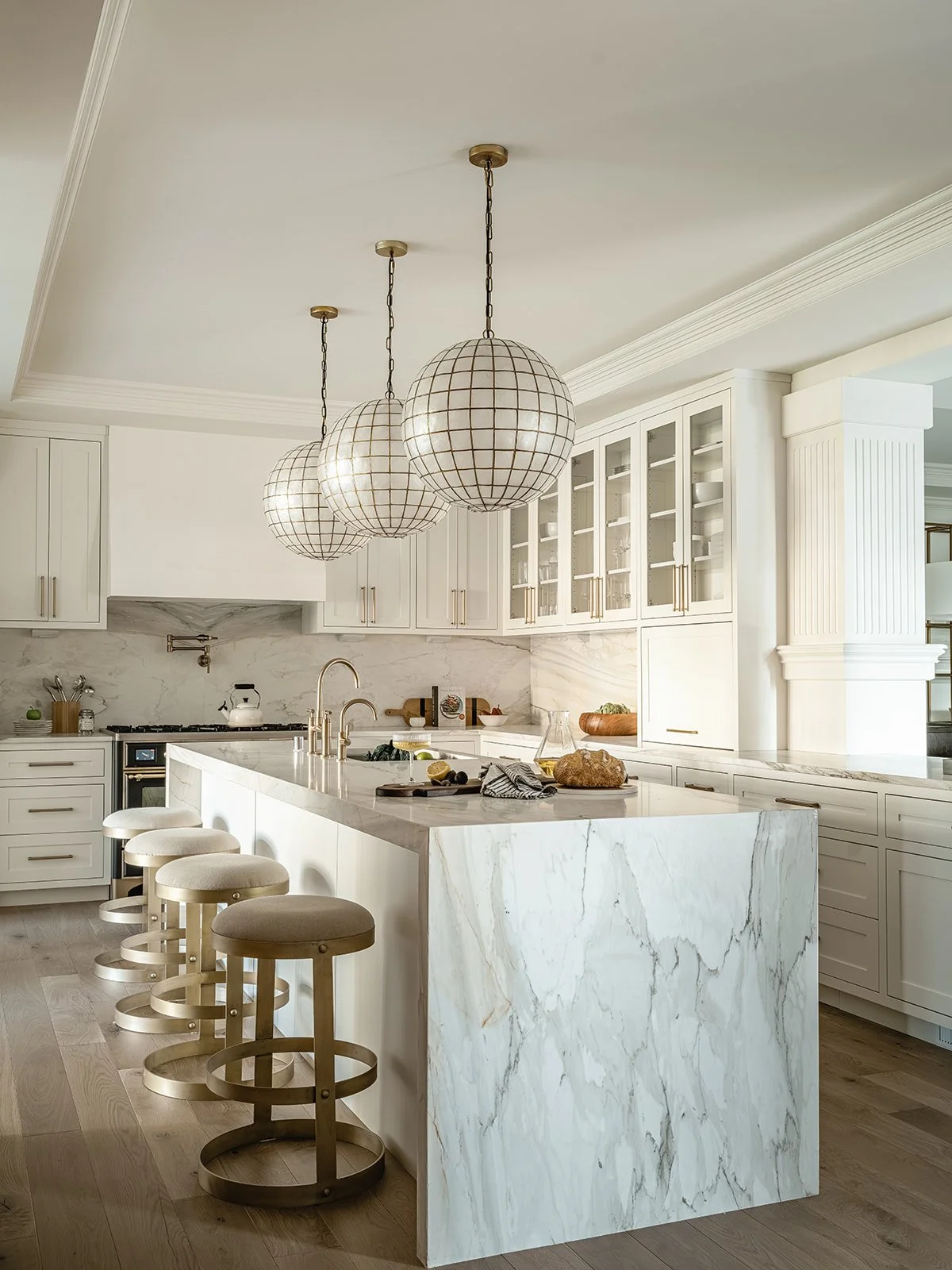 Sunlit kitchen with marble island