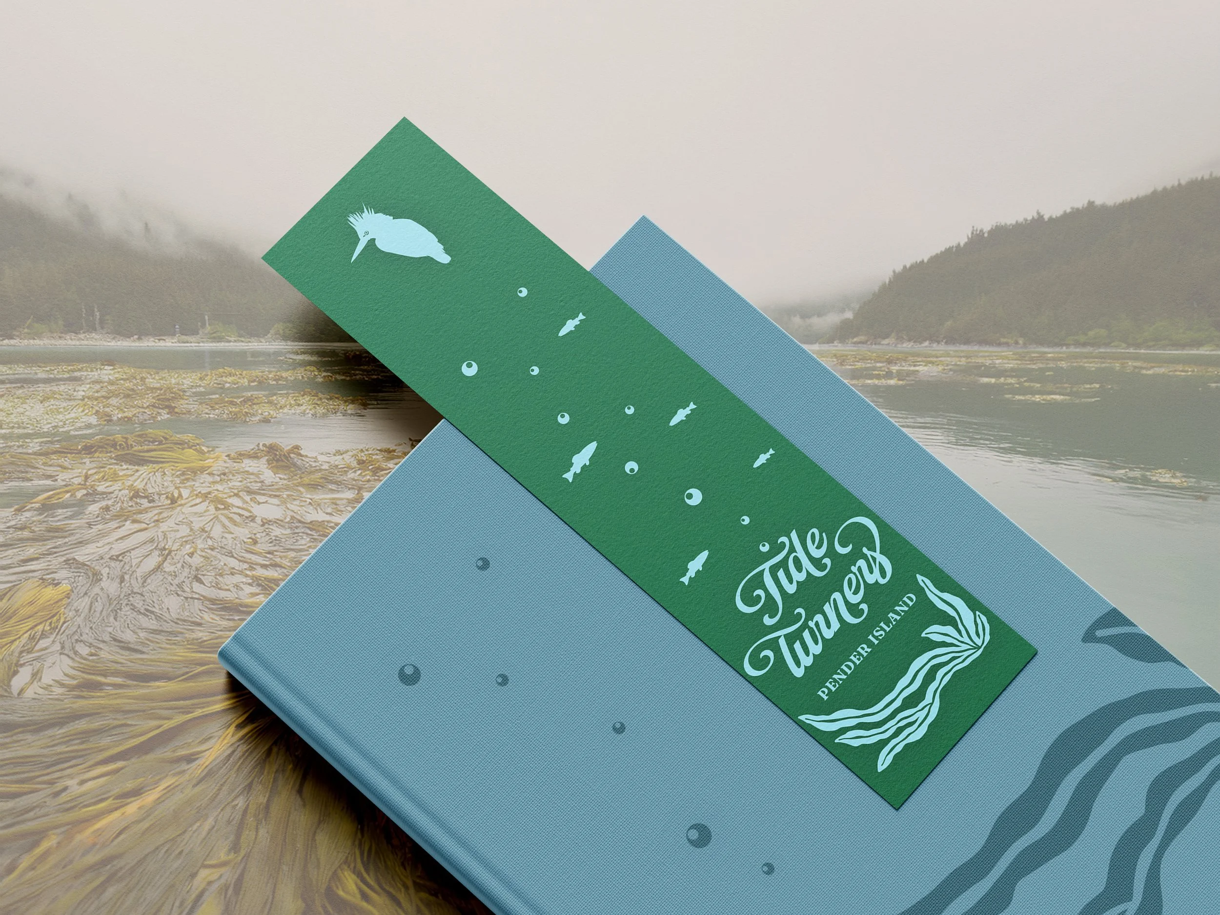 Mockup of a bookmark sitting on top of a book and an ocean faded background.
