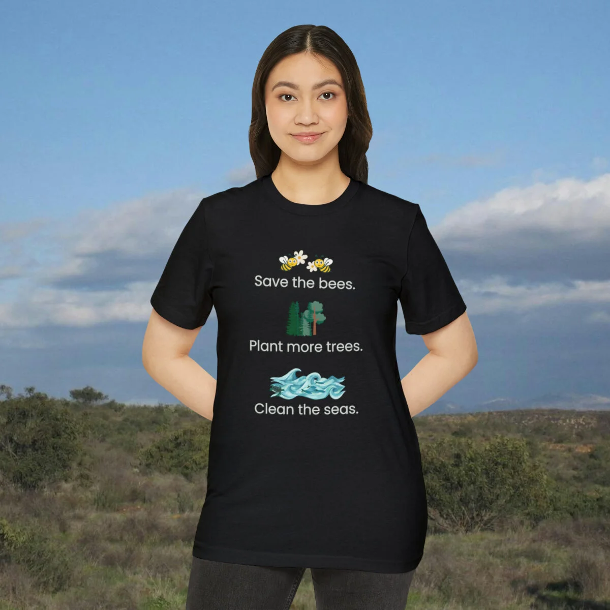 Women standing in t shirt that says "Save the bees, plant more trees, clean the seas" made with recycled polyester