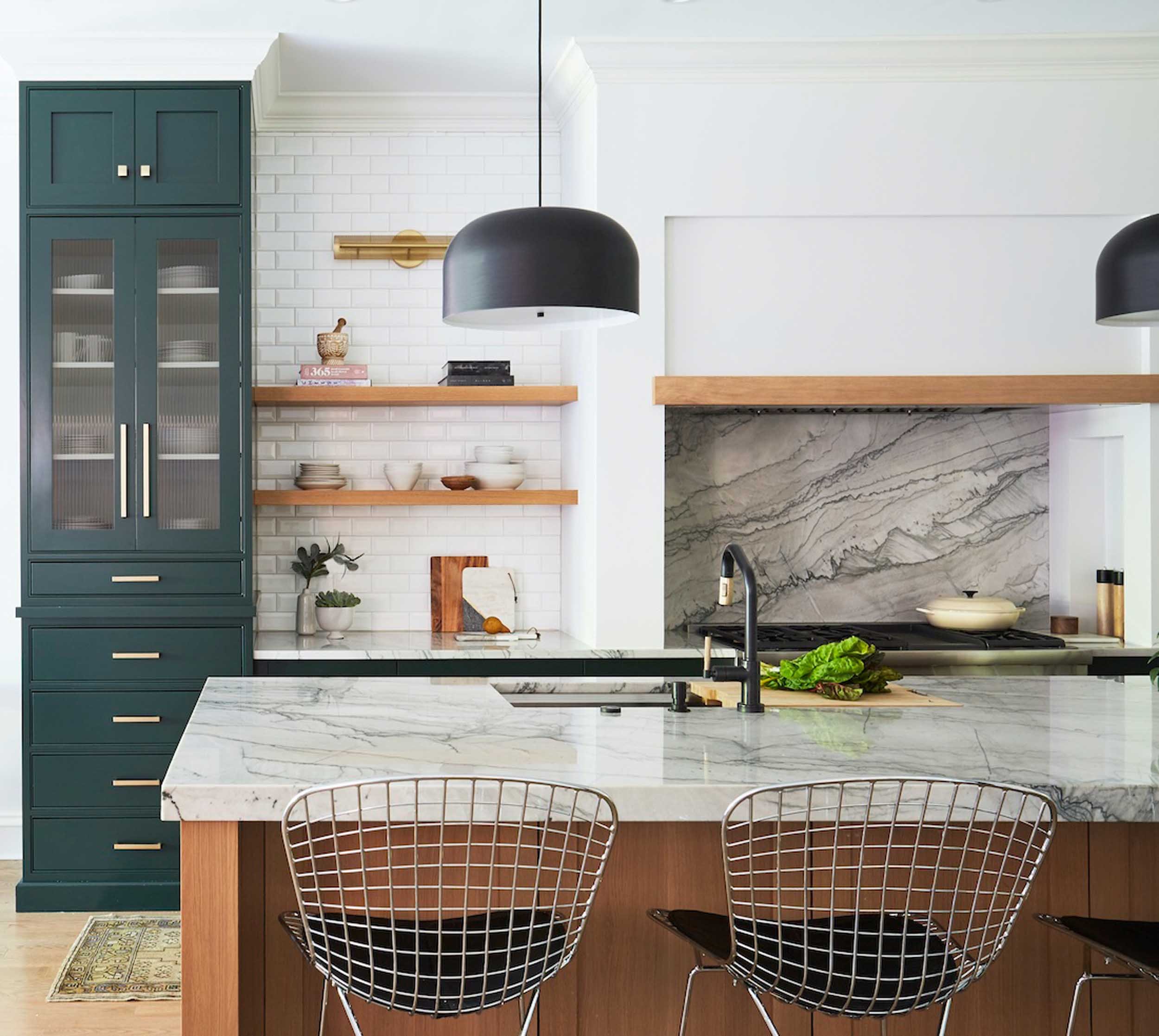 Gorgeous kitchen with marble countertops and green cabinets