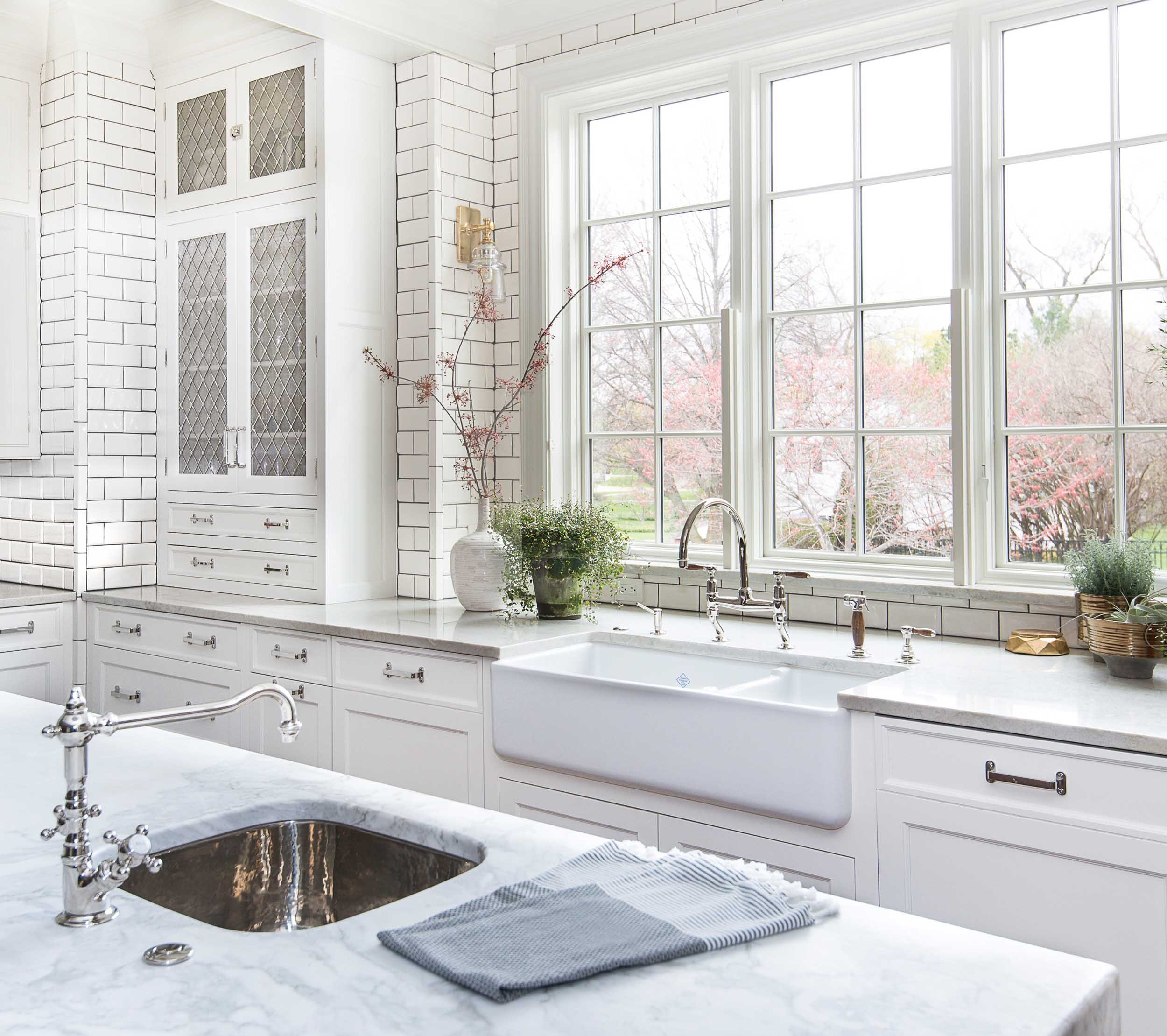 shiny sparkling white kitchen with subway tiles, white marble countertops and custom cabinetry