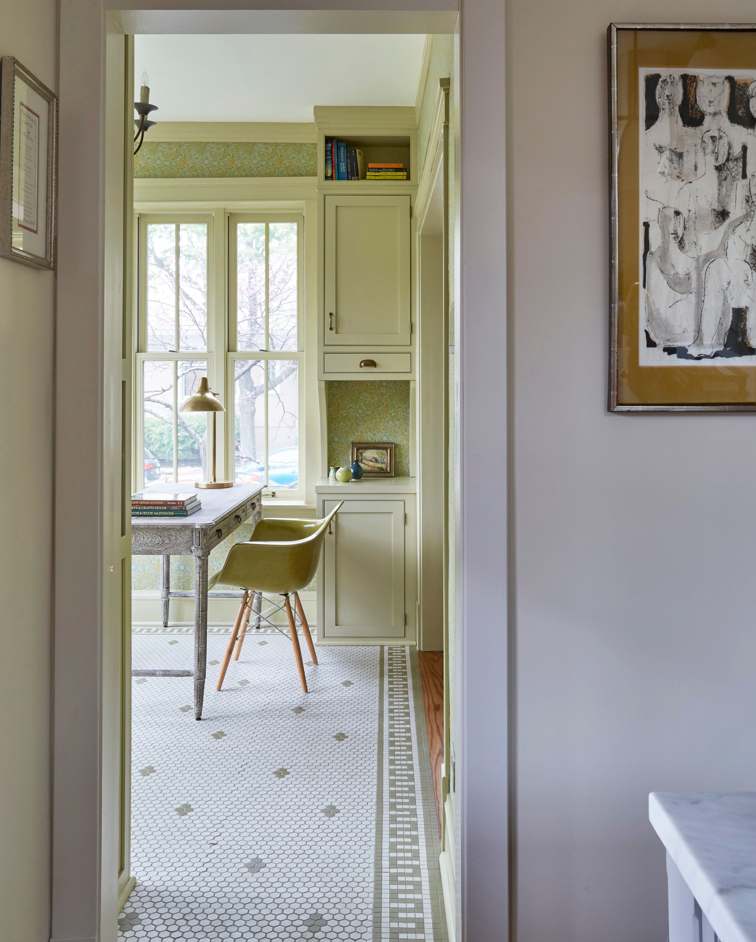 Bright yellow walk-in pantry with gray oak desk, small hexagonal white tile, and grey desk chair, Sunnyside by KitchenLab Interiors