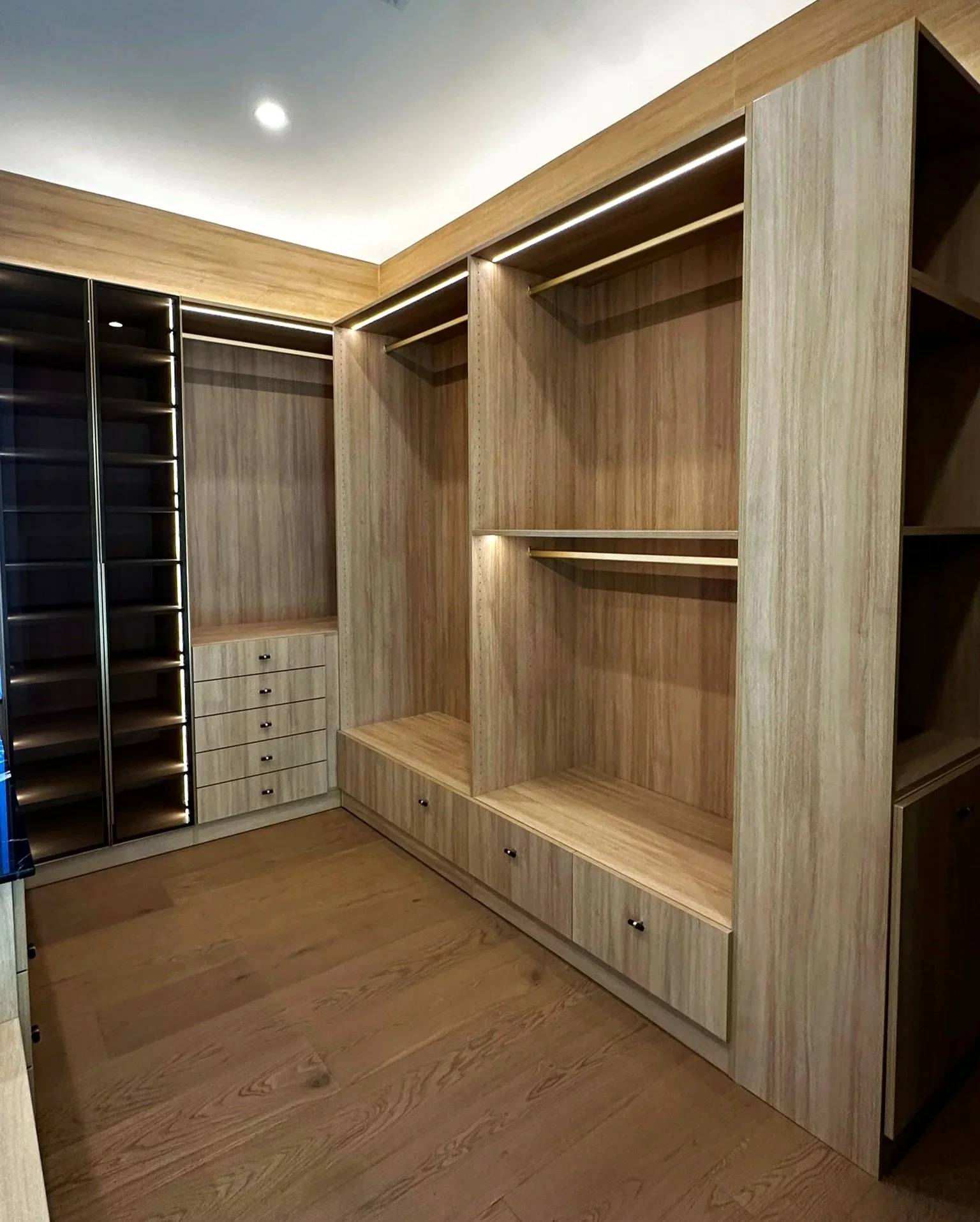 Walk in master closet, full custom millwork to ceiling, rift oak, drawers, double and long hangs, drawer stacks, full height gold glass doors