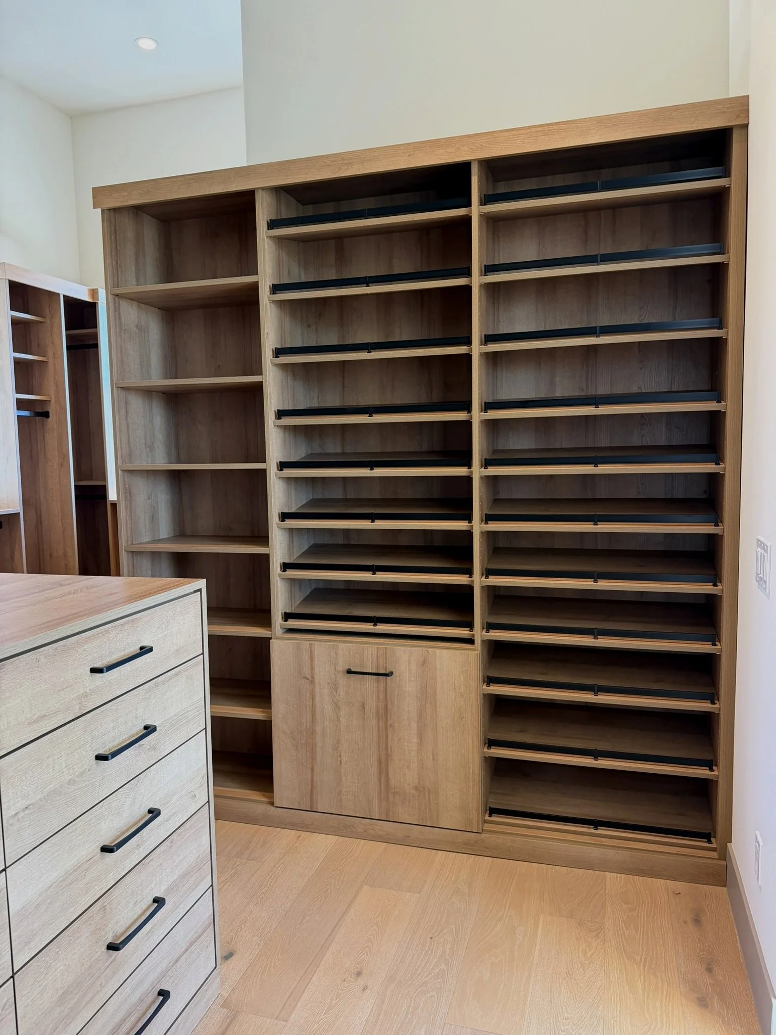 walk in master closet, shoe storage, shoe rails, 5 drawer high island with wood top