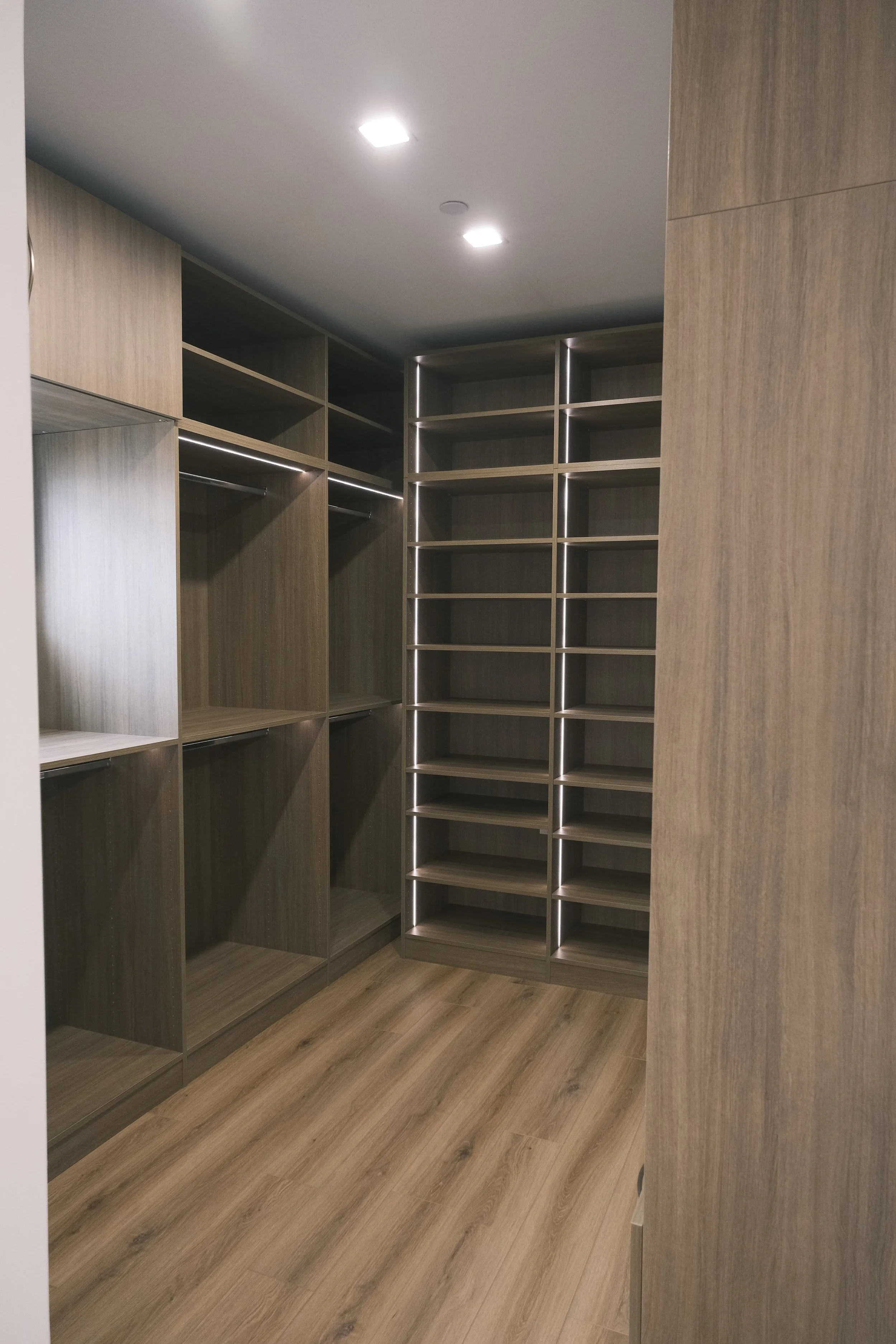 Walk in master closet, integrated lighting, full backs, closed and open storage above.