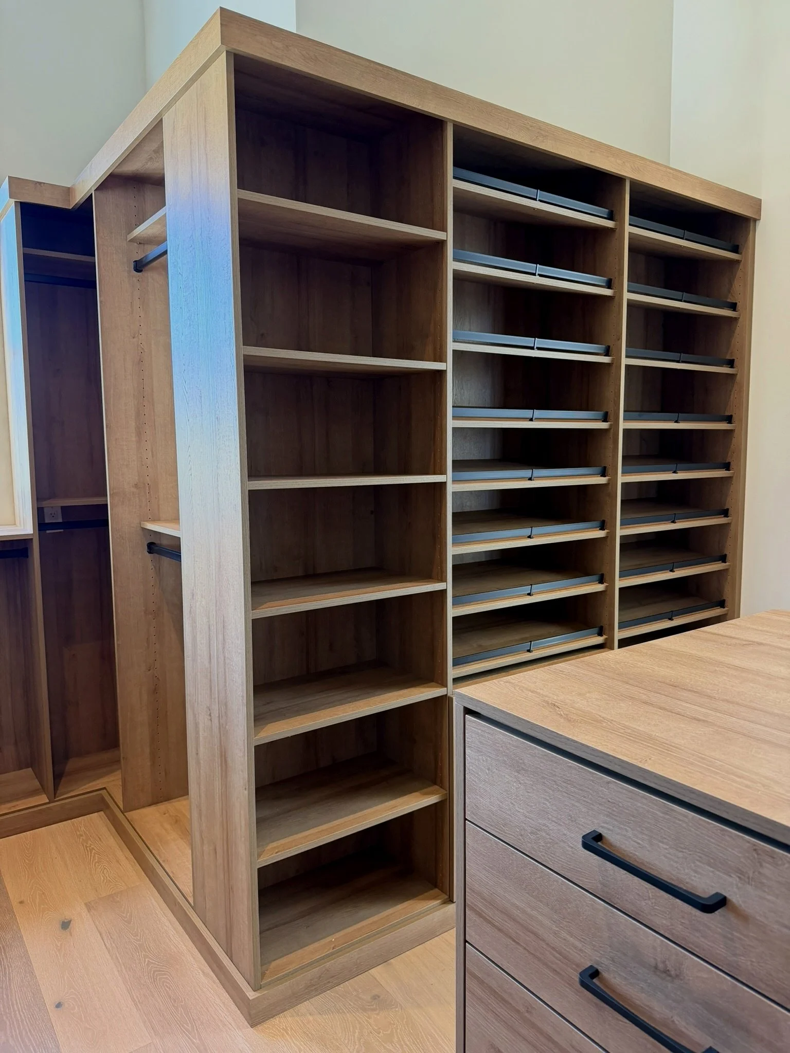 open shelving storage, back side of island drawers, shoe storage, wood tone