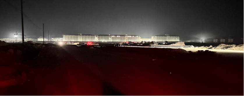 Ace of Spades compound, Cambodia. A massive building complex in the middle of a rural field at night. Multiple multi-story buildings that look like an office or housing complex. Photo by Erin West, Operation Shamrock, February 2026.