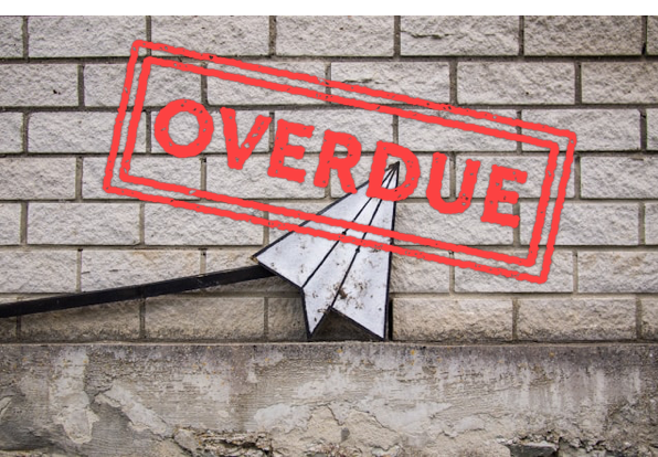 A paper airplane in front of a grey brick wall with a red "Overdue" stamp over the image.