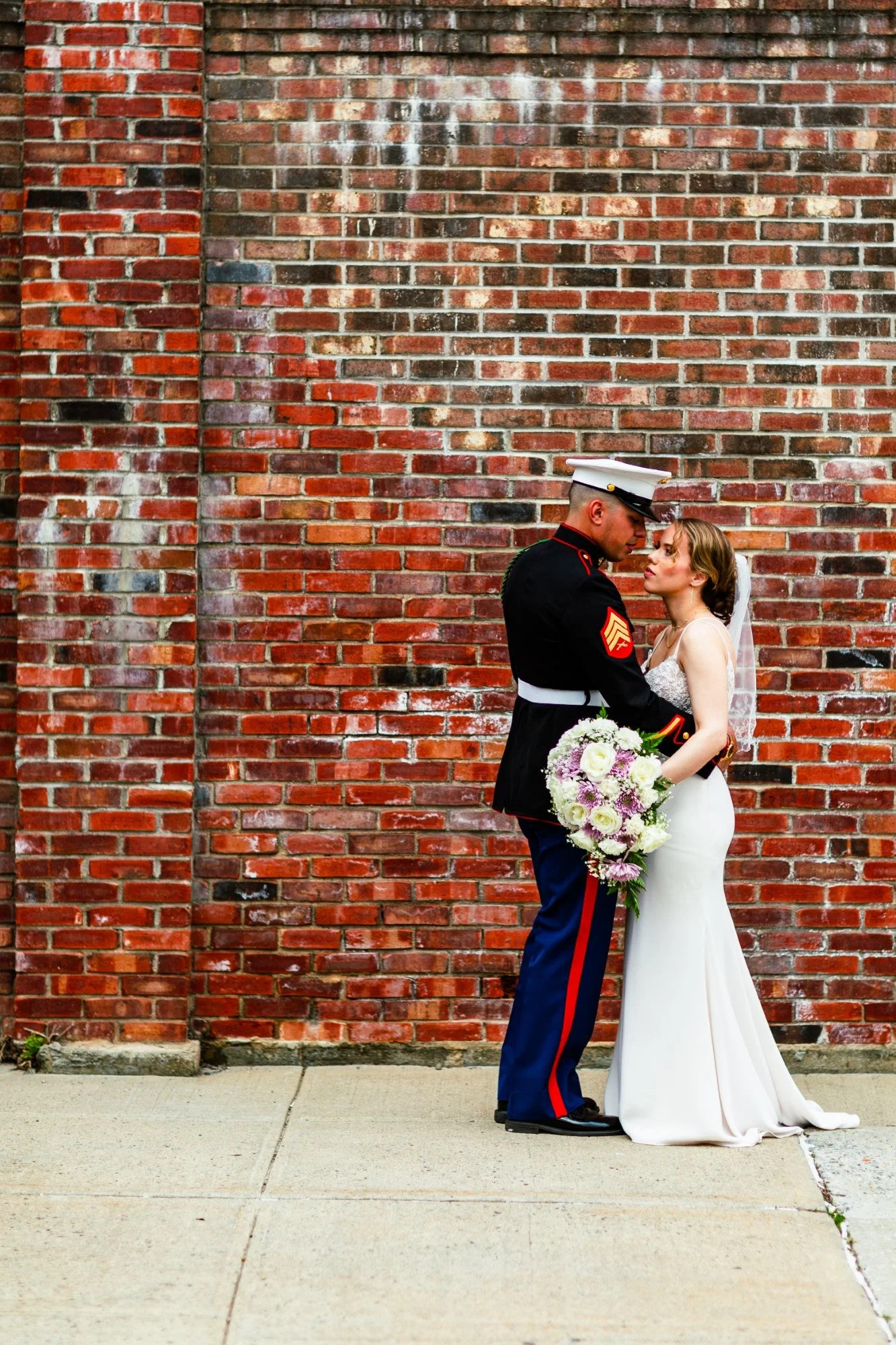 Woman stepping out of a luxury car at night, smiling, wearing a black dress and heels.