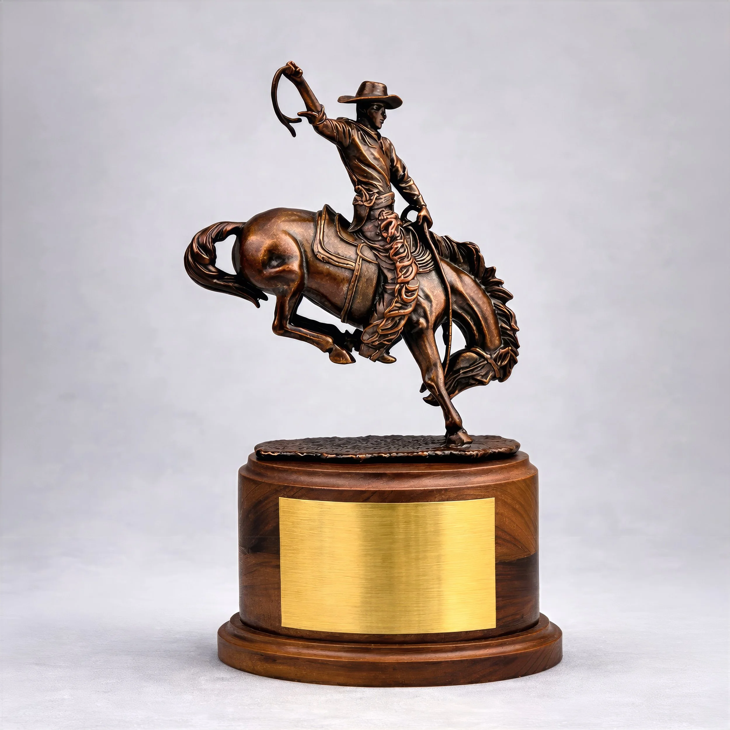Custom cast metal cowboy on a bucking bronco statue by Polaris Custom Awards.