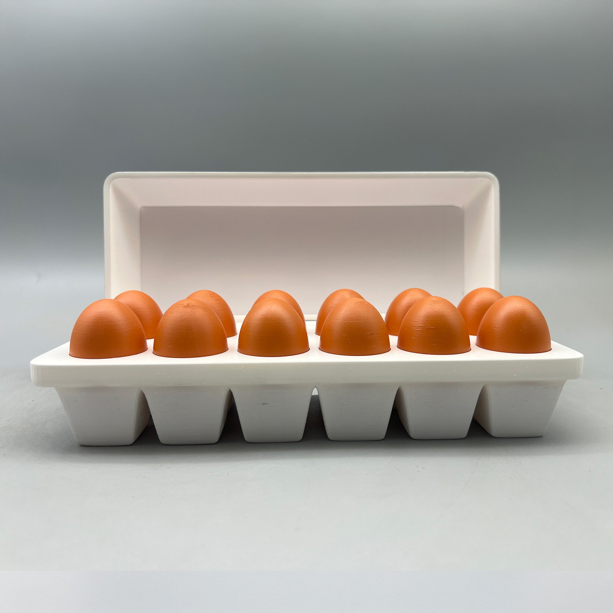Custom agribusiness deal toy designed as a sculptural egg carton with stylized eggs, created to commemorate a food industry or agriculture transaction through product-inspired symbolism and custom recognition design.