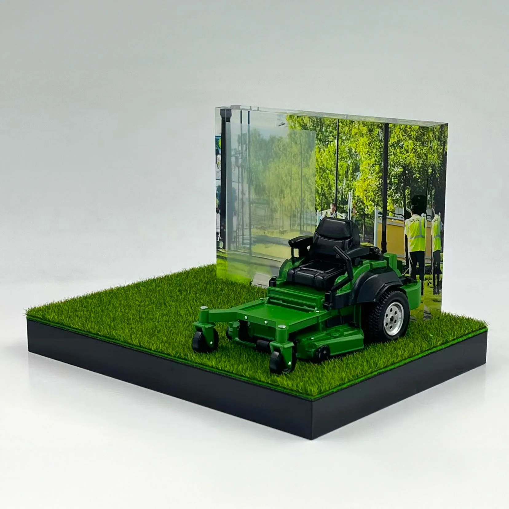 Custom sculptural deal toy with 3D miniature riding lawn mower on grassy base by Polaris Custom Awards