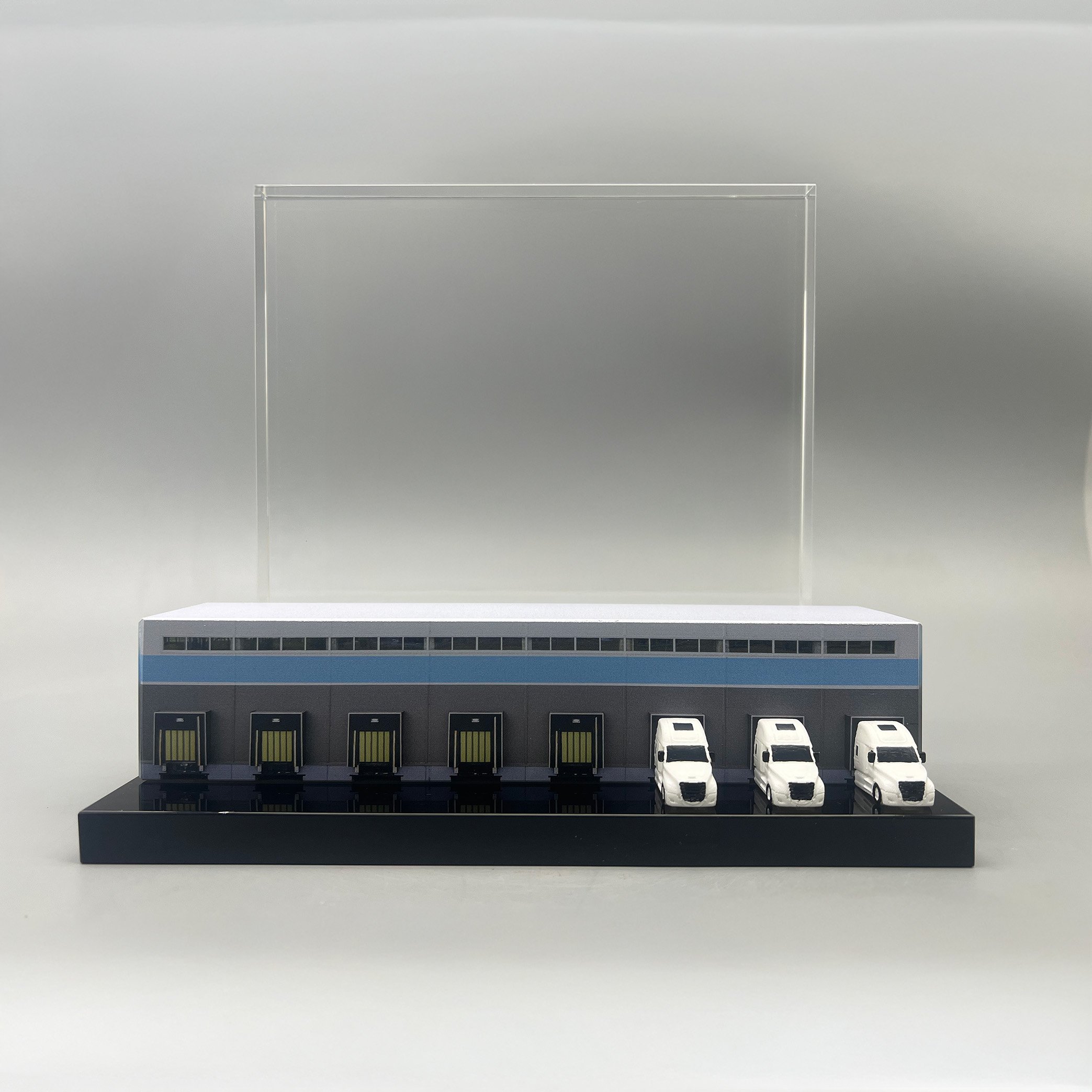 Custom industrial deal toy depicting a warehouse distribution center with loading docks and delivery trucks.