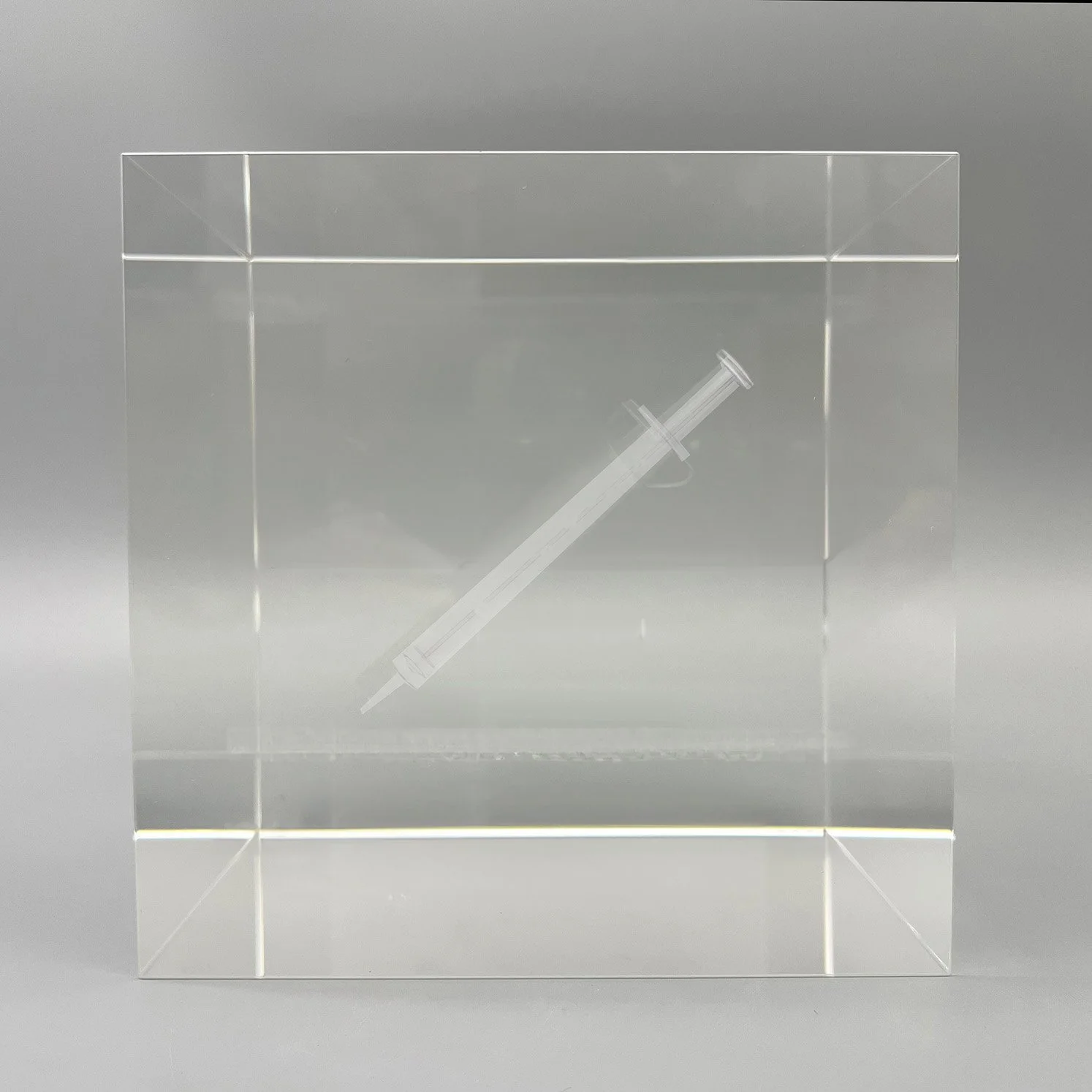 Custom crystal cube deal toy with 3D laser etched syringe by Polaris Custom Awards.