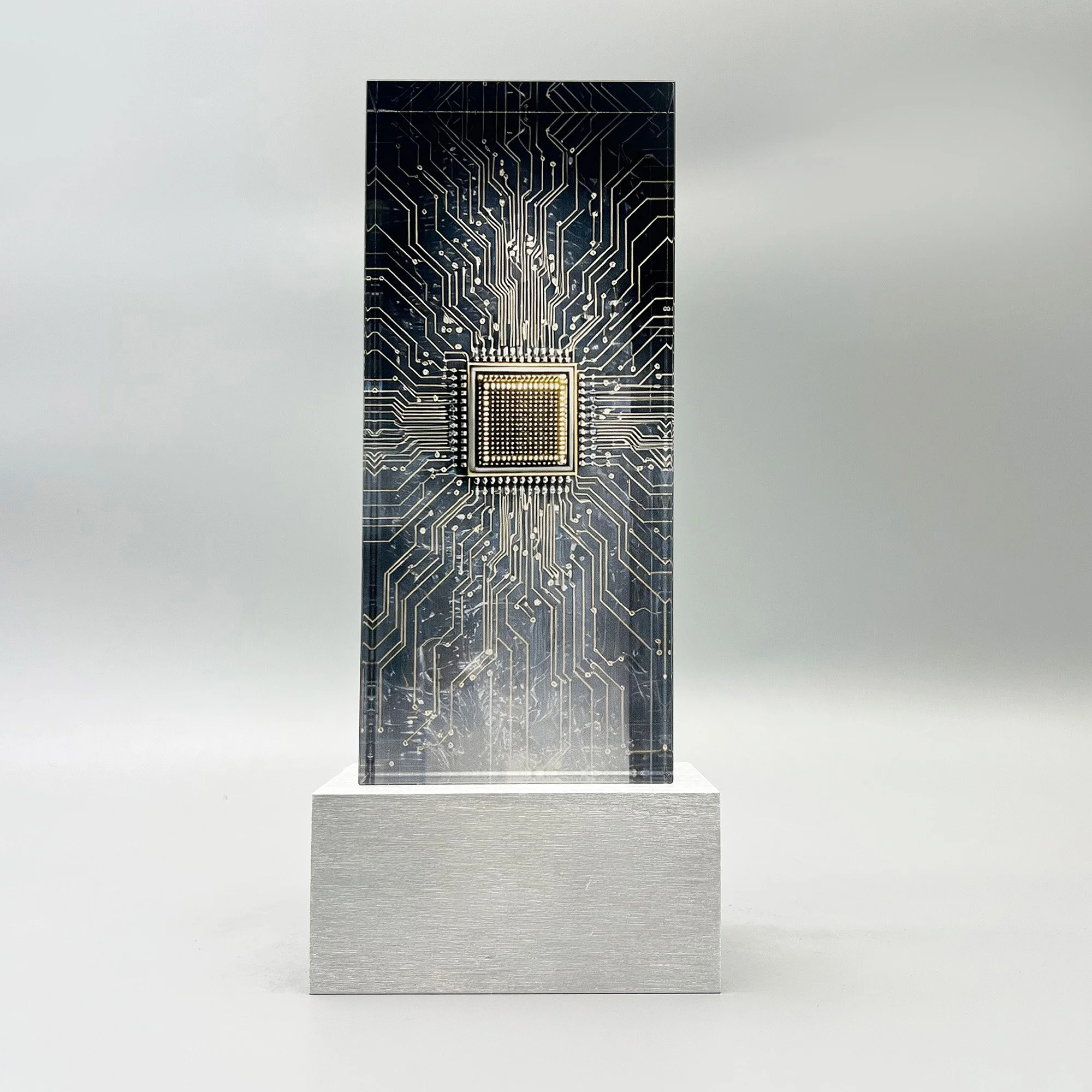 Semiconductor deal toy with a metallic circuit pattern and central chip on a stone-textured base.