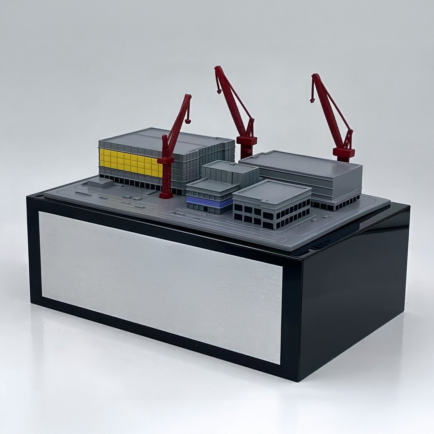 Resin miniature semiconductor fabrication plant with cranes and facility details.