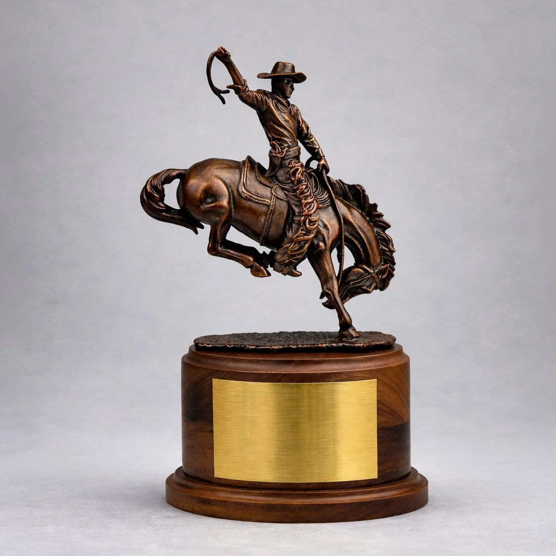 Bronze cowboy rider sculpture mounted on wood base with metal plaque, Frederic Remington inspired commemorative deal marker emphasizing sculptural craftsmanship and permanence.