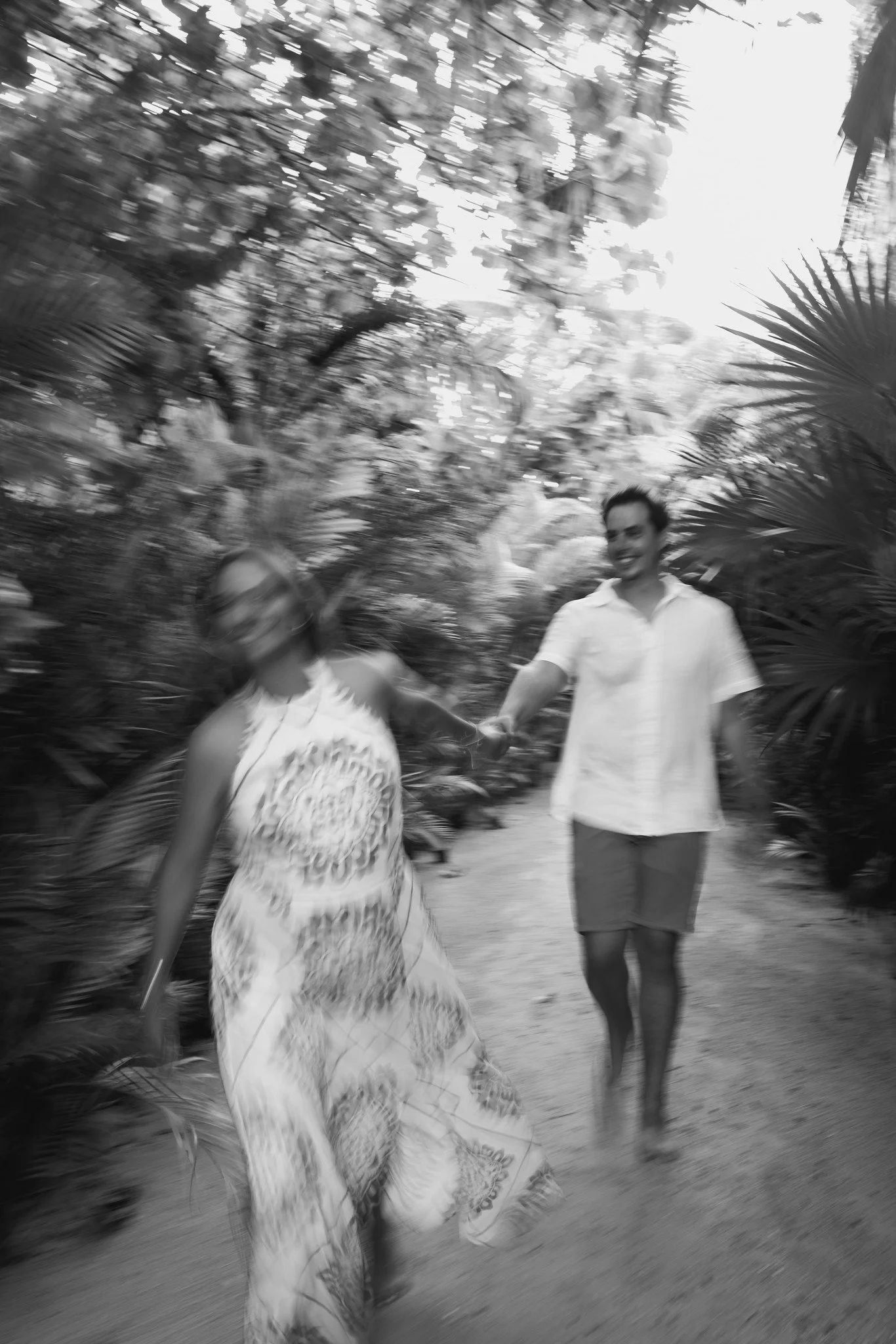Couple photoshoot in Tulum mexico for their engagement holding hands together when they are laughing at the photoshoot