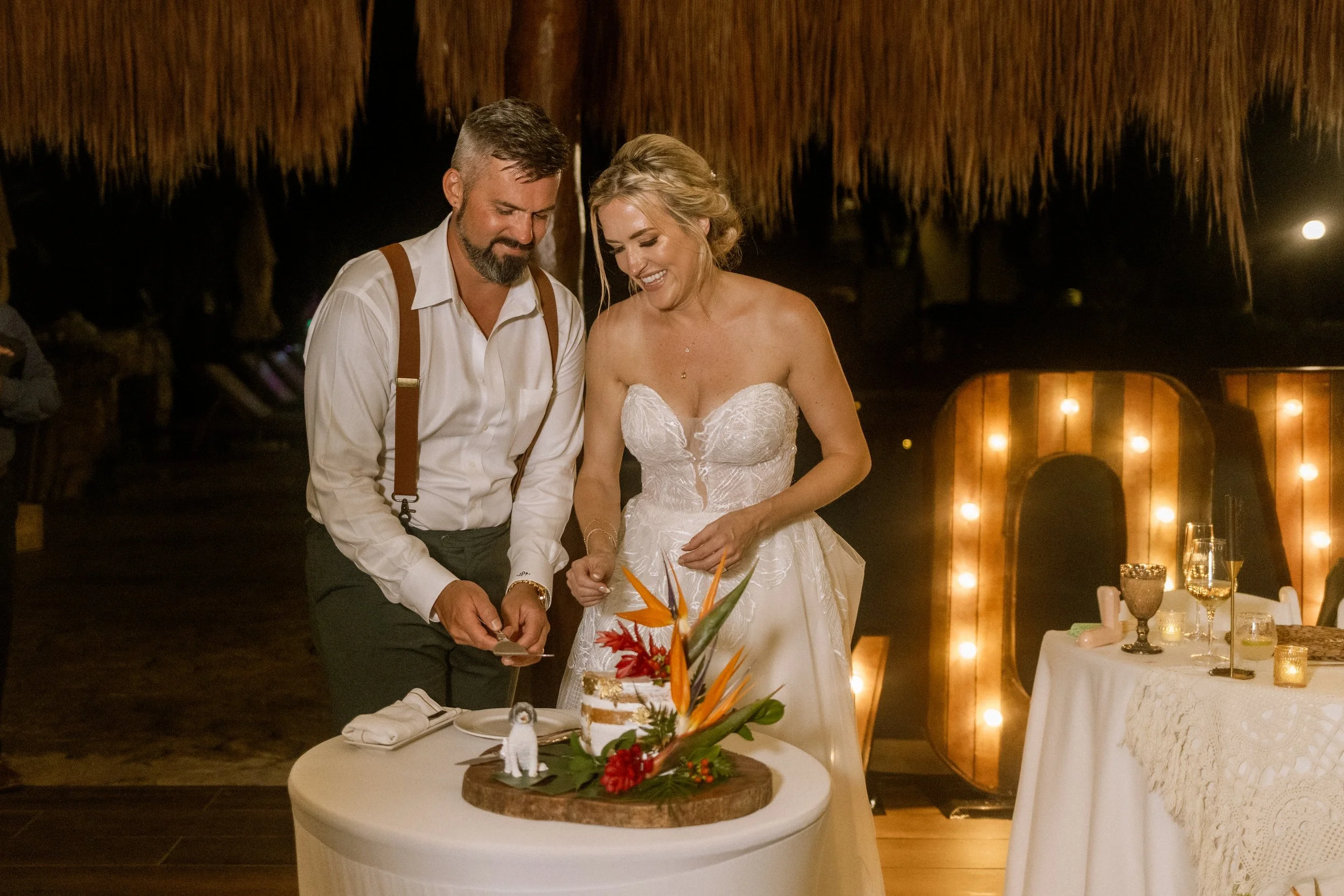 Couple cutting the cake at the sweetest moement of the day at their wedding