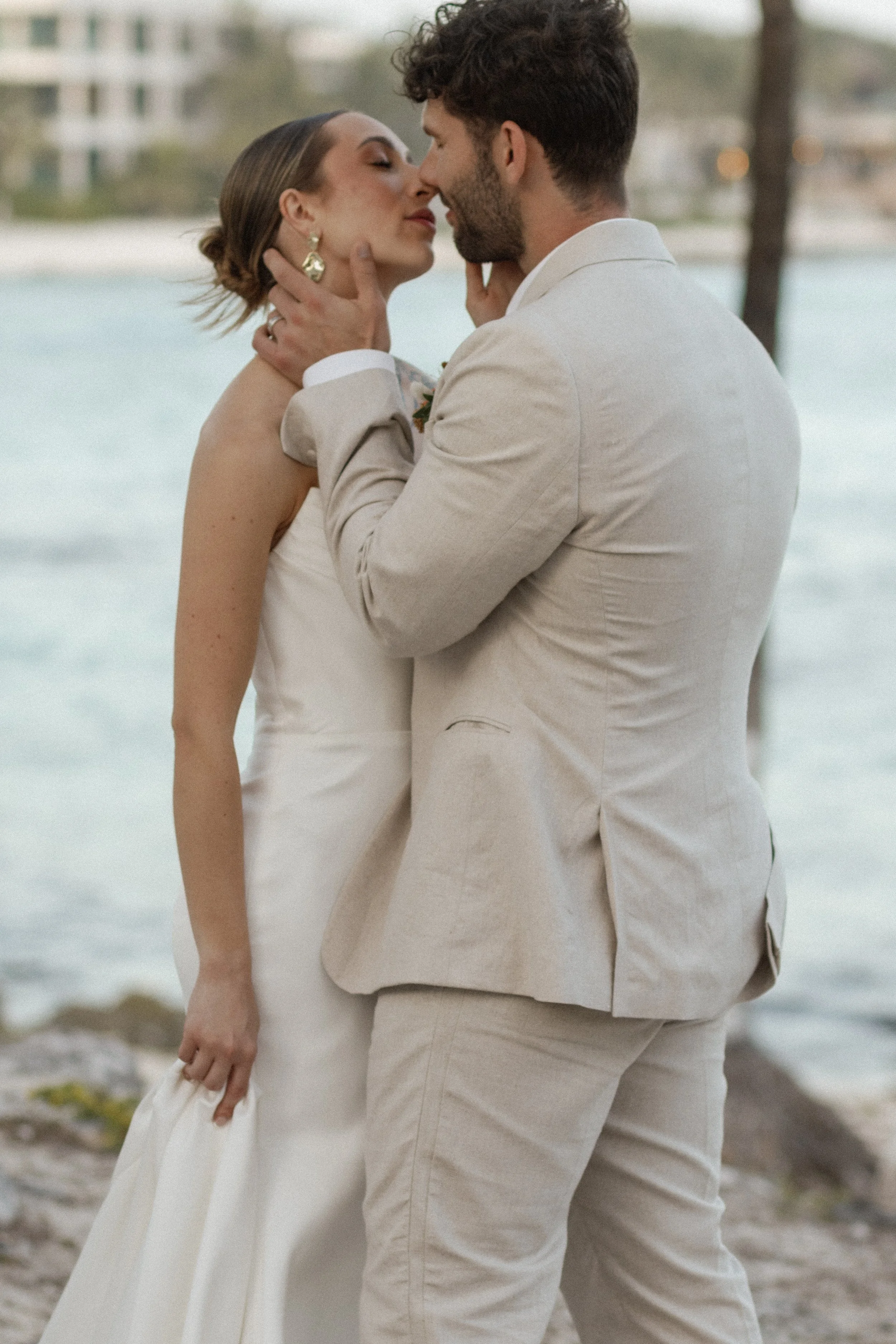 he ultimate celebratory kiss, surrounded by cheering loved ones under swaying palms. This moment perfectly encapsulates