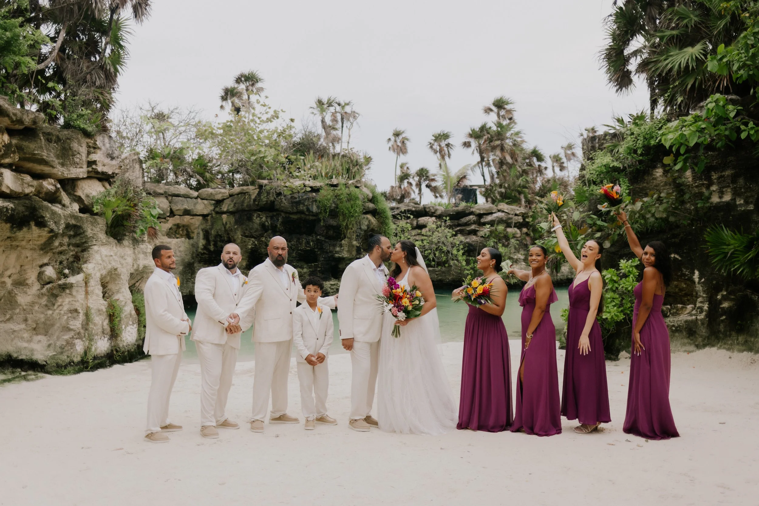 xcaret arte hotel wuth a group photo of the bridal party at the wedding of the bride and groom