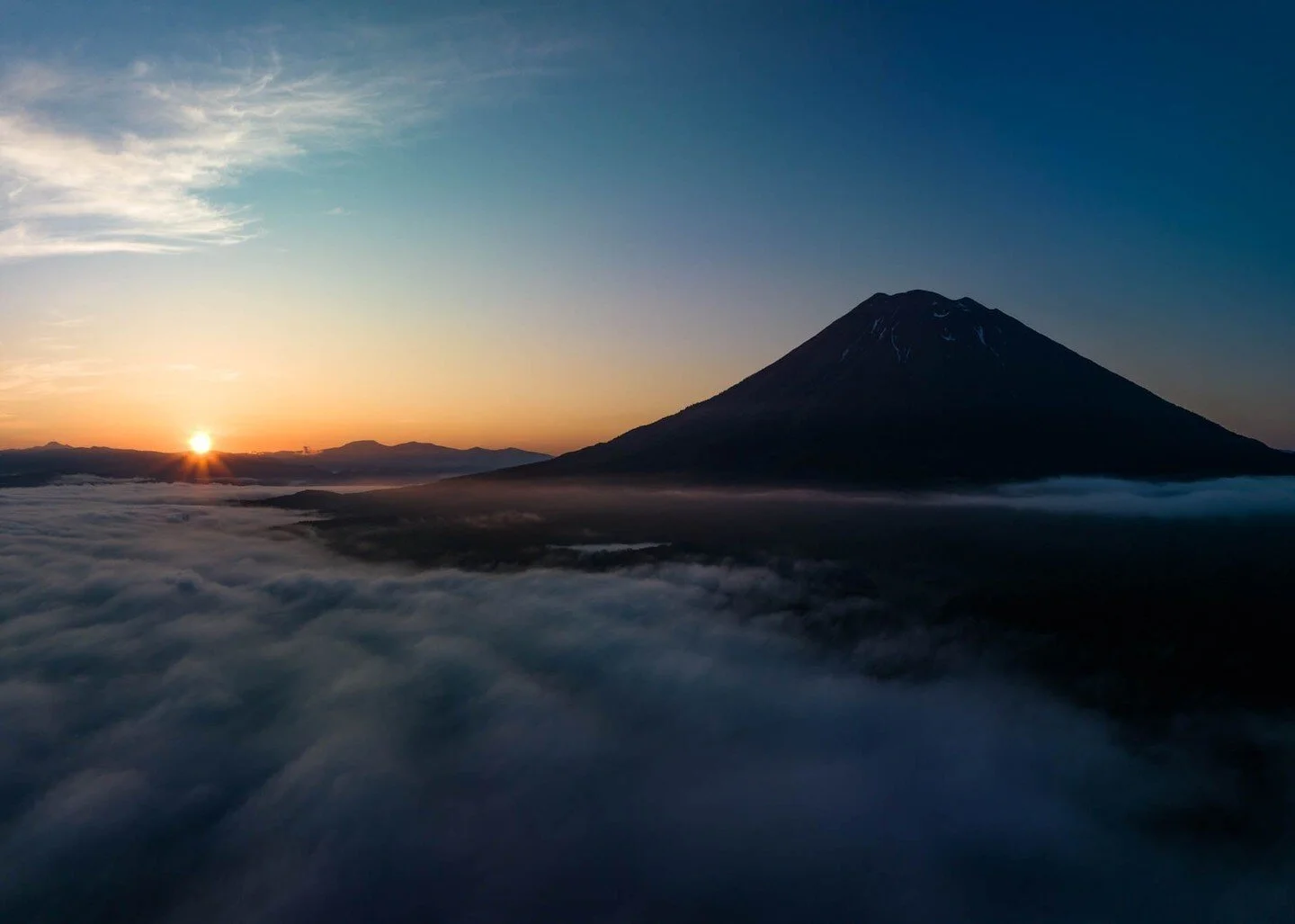 Captured the first rays of light hitting Mt. Yotei, Hokkaido's answer to Mt. Fuji. 🌄 Did you know Mt. Yotei's crater is filled with snow almost year-round, making it a hidden sanctuary above the clouds? 
#MtYotei #Hokkaido #Sunrise #JapanNature #Mou