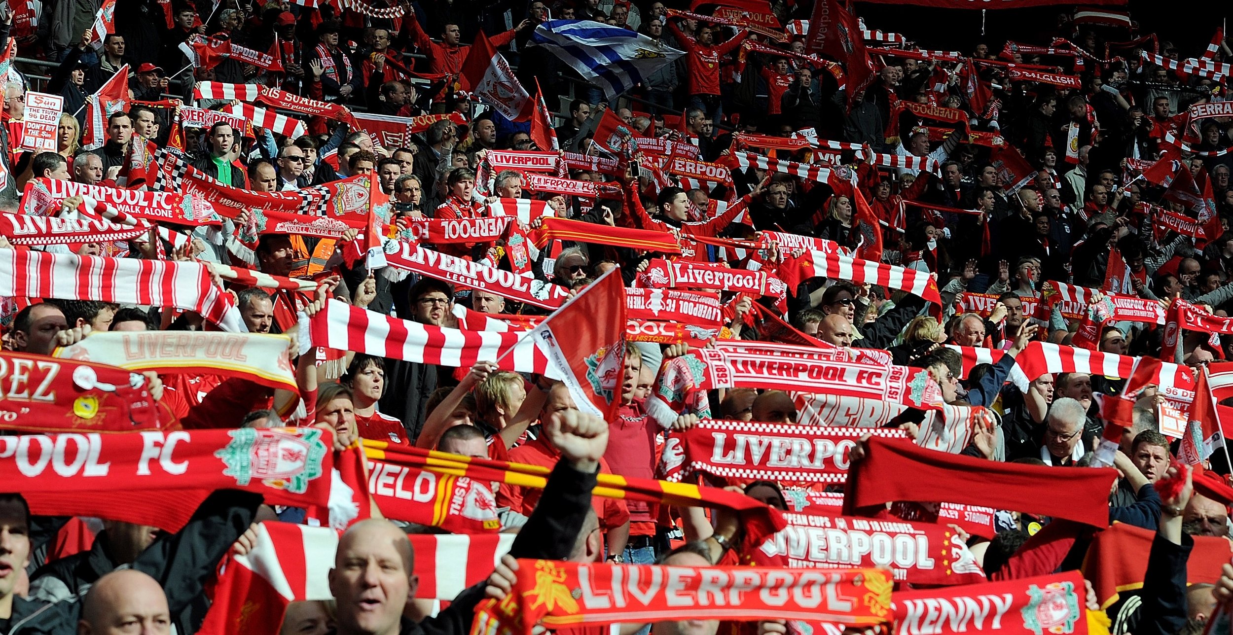 Liverpool fans holding up scarves