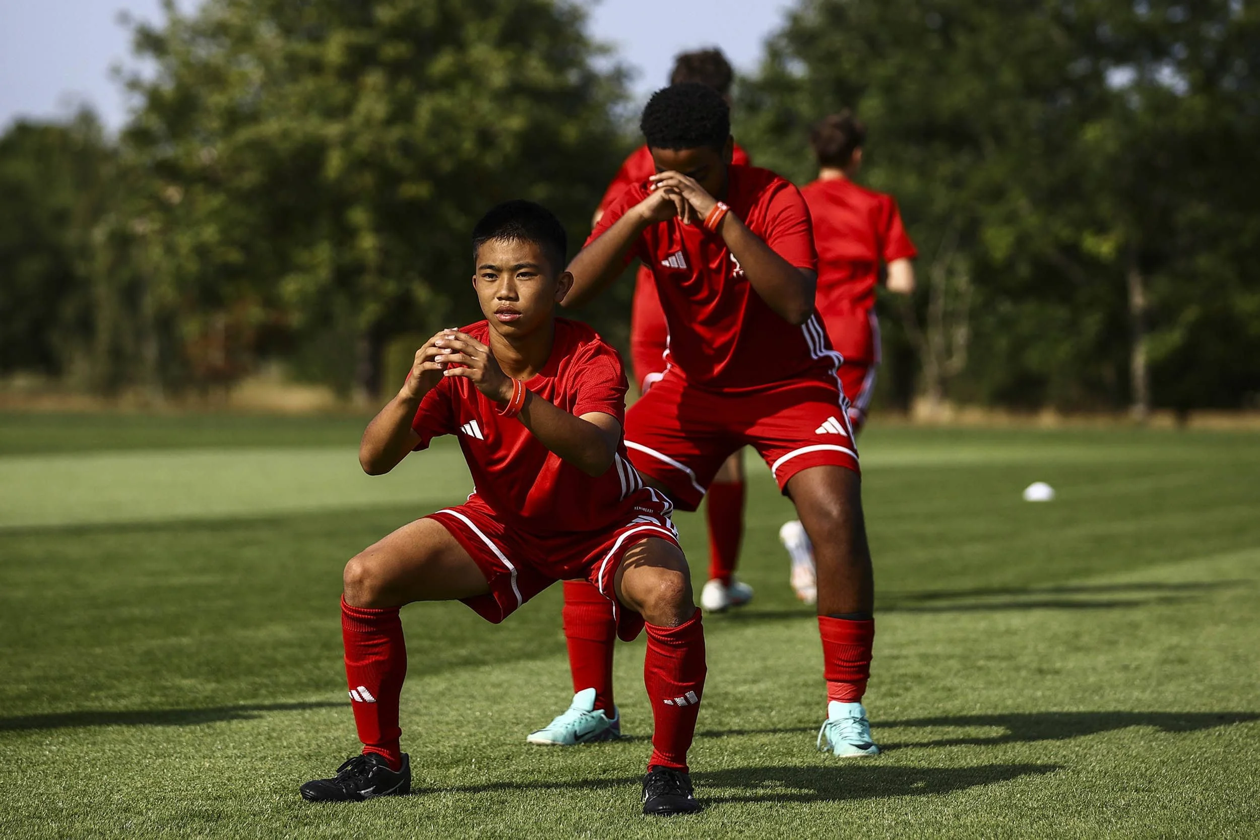 Players on football camp warming up for training