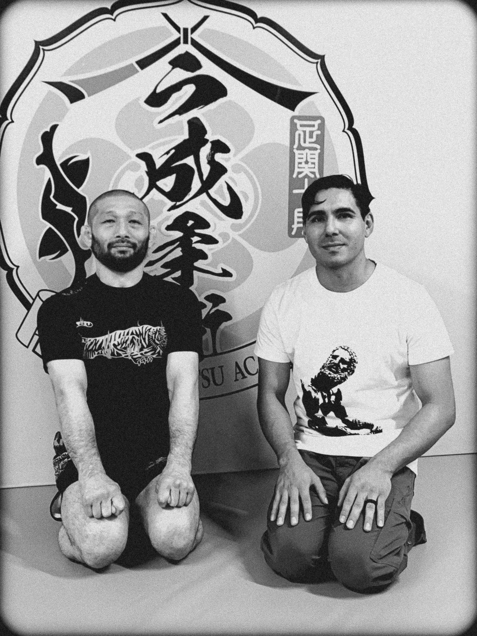 Black-and-white portrait inside Imanari Jiu-Jitsu Academy in Tokyo, Japan, Iminari with the boxer