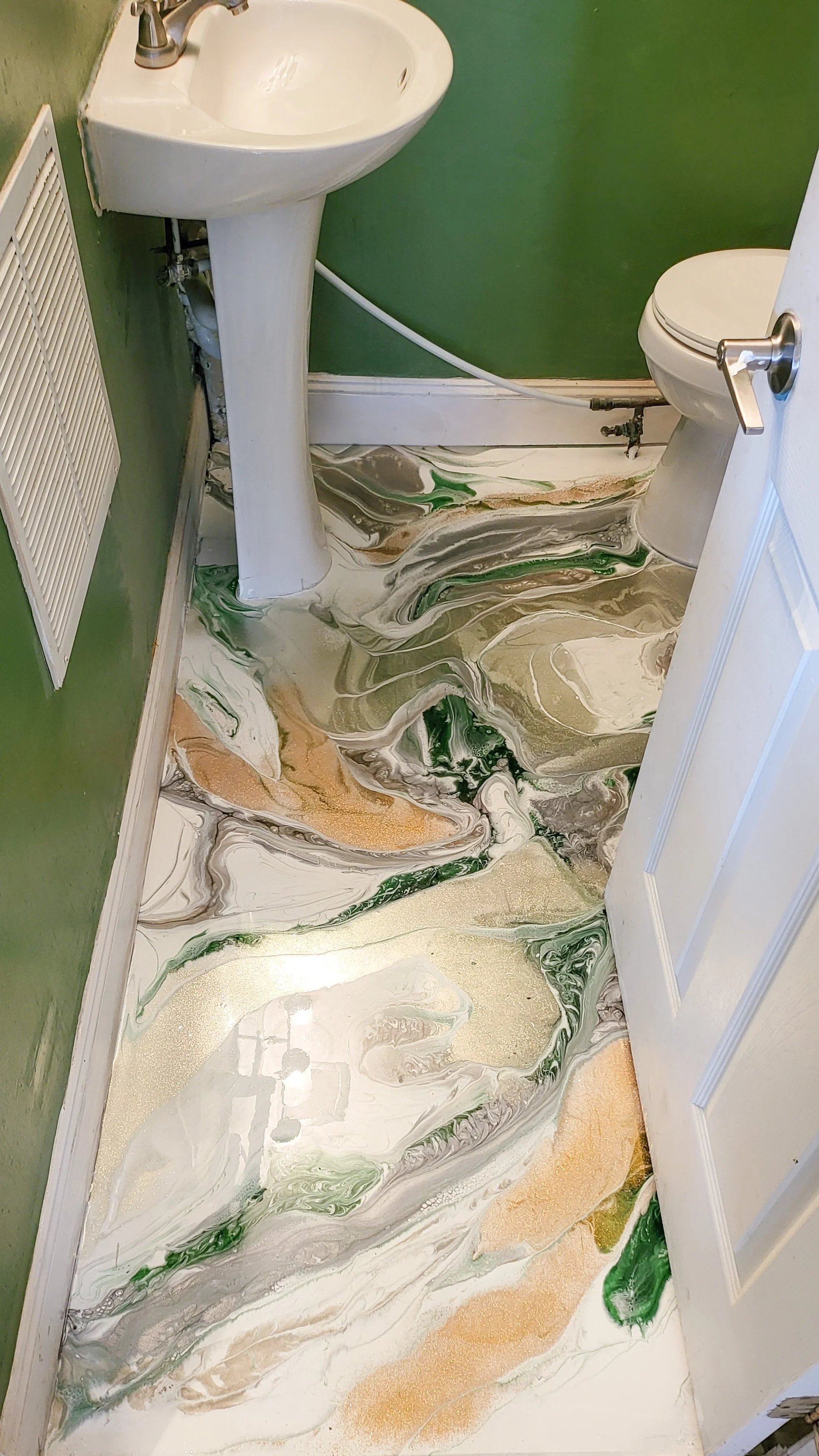 Bathroom with green walls and a marble-patterned epoxy floor in shades of white, green, tan, and beige.
