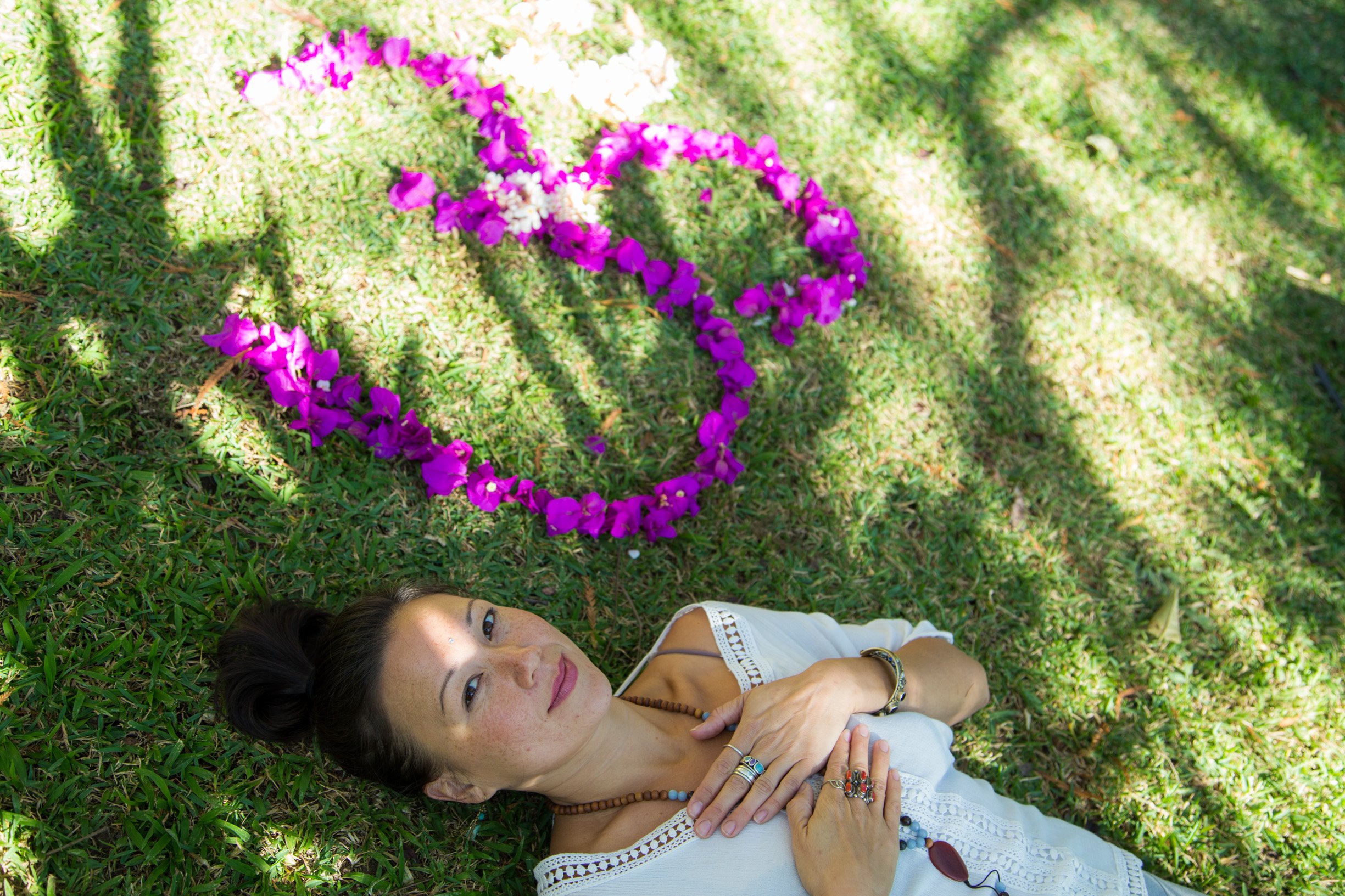 Woman lying on the grass healing from psychedelic journey