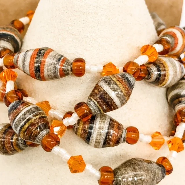 Necklace and earrings set.  28” strand of neutral color paper beads with a touch of orange and amber strung with crystal and seed beads. (Item 16)