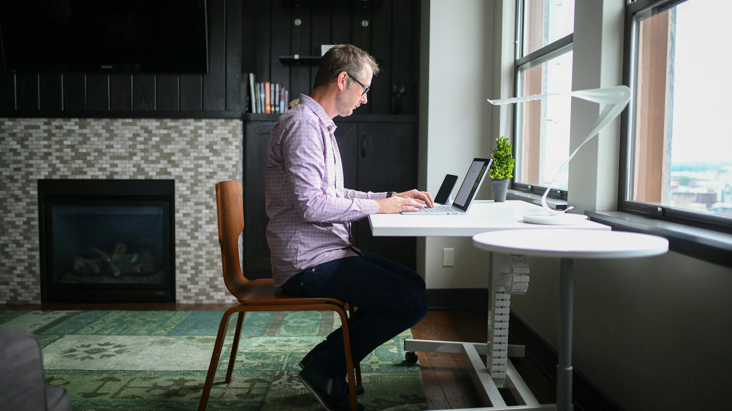 Image of a nonprofit leader working at his desk and contacting potential donors and funders through investment-level communication and relationships.