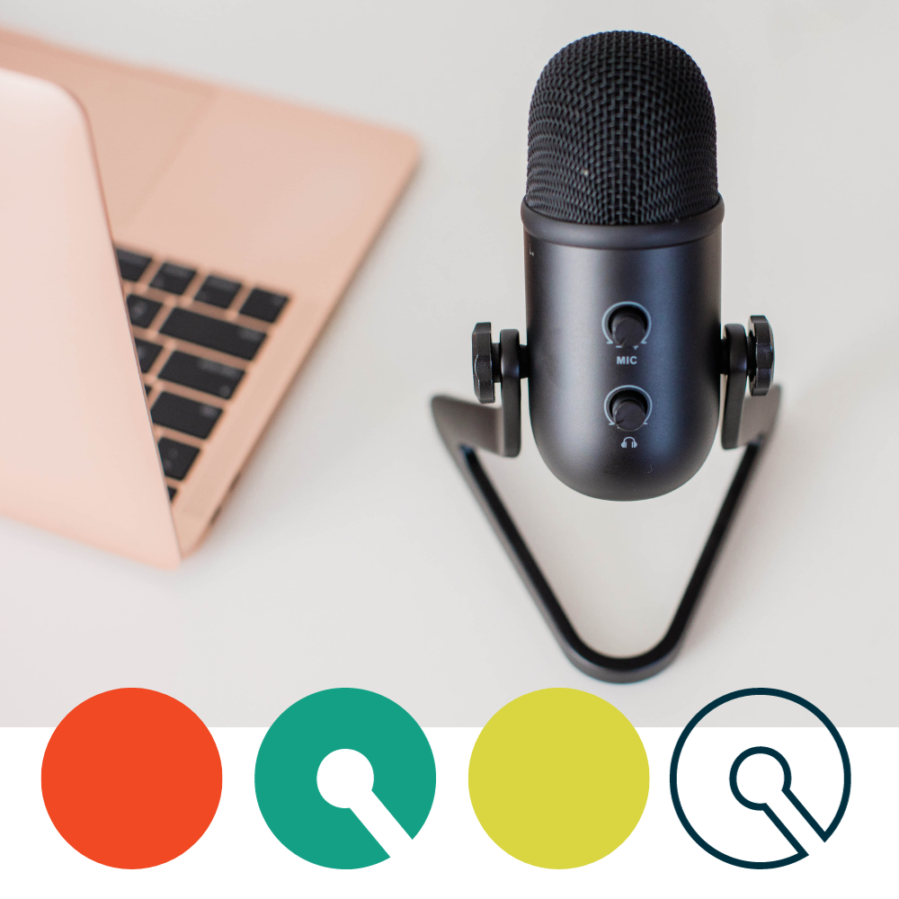 Image of a podcast microphone and an open laptop computer
