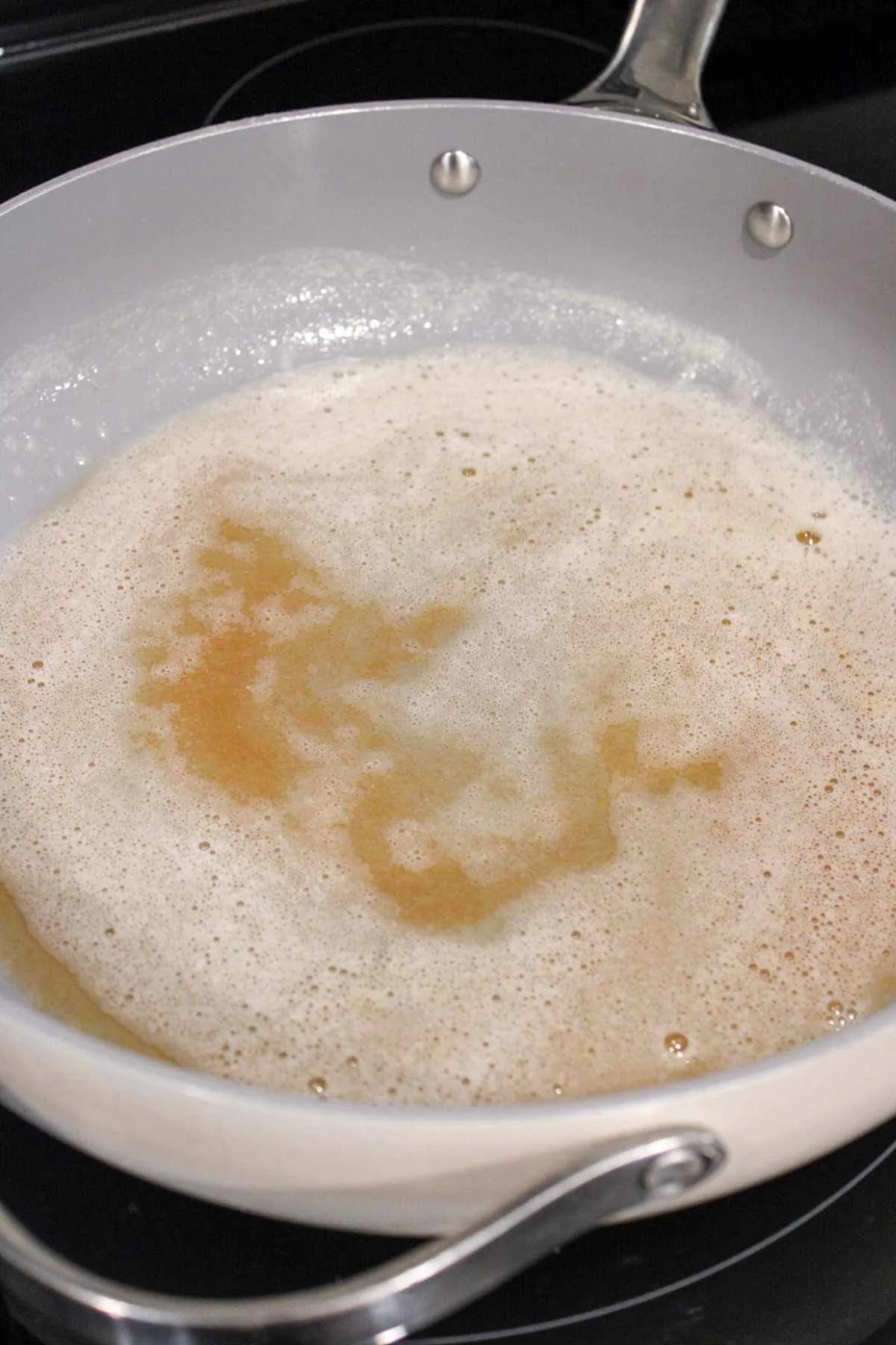 large pan showing the process of browning butter.