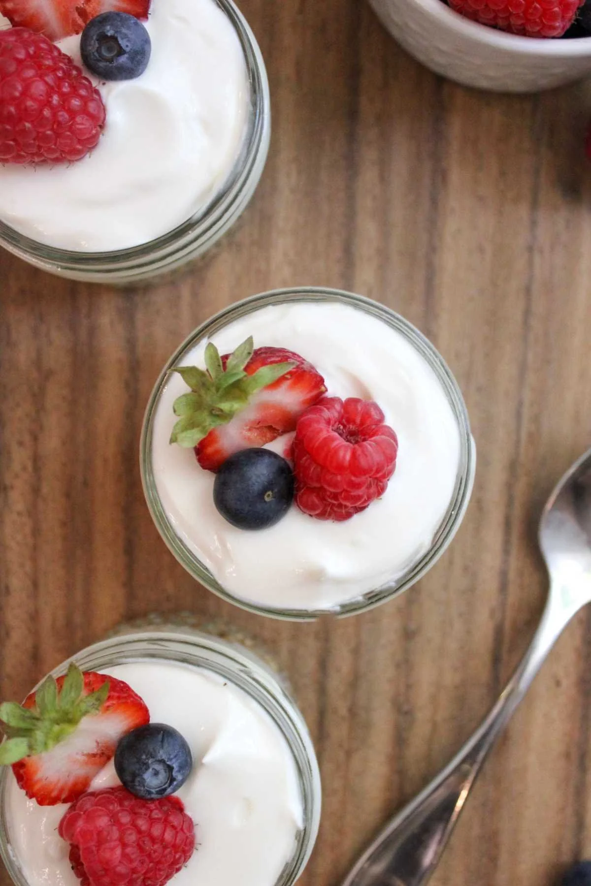 high protein cheesecake cups topped with freshly washed berries.
