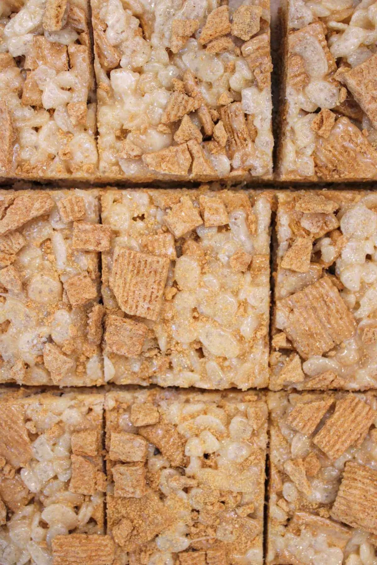closely stacked brown butter golden graham Rice Krispies all touching each other.