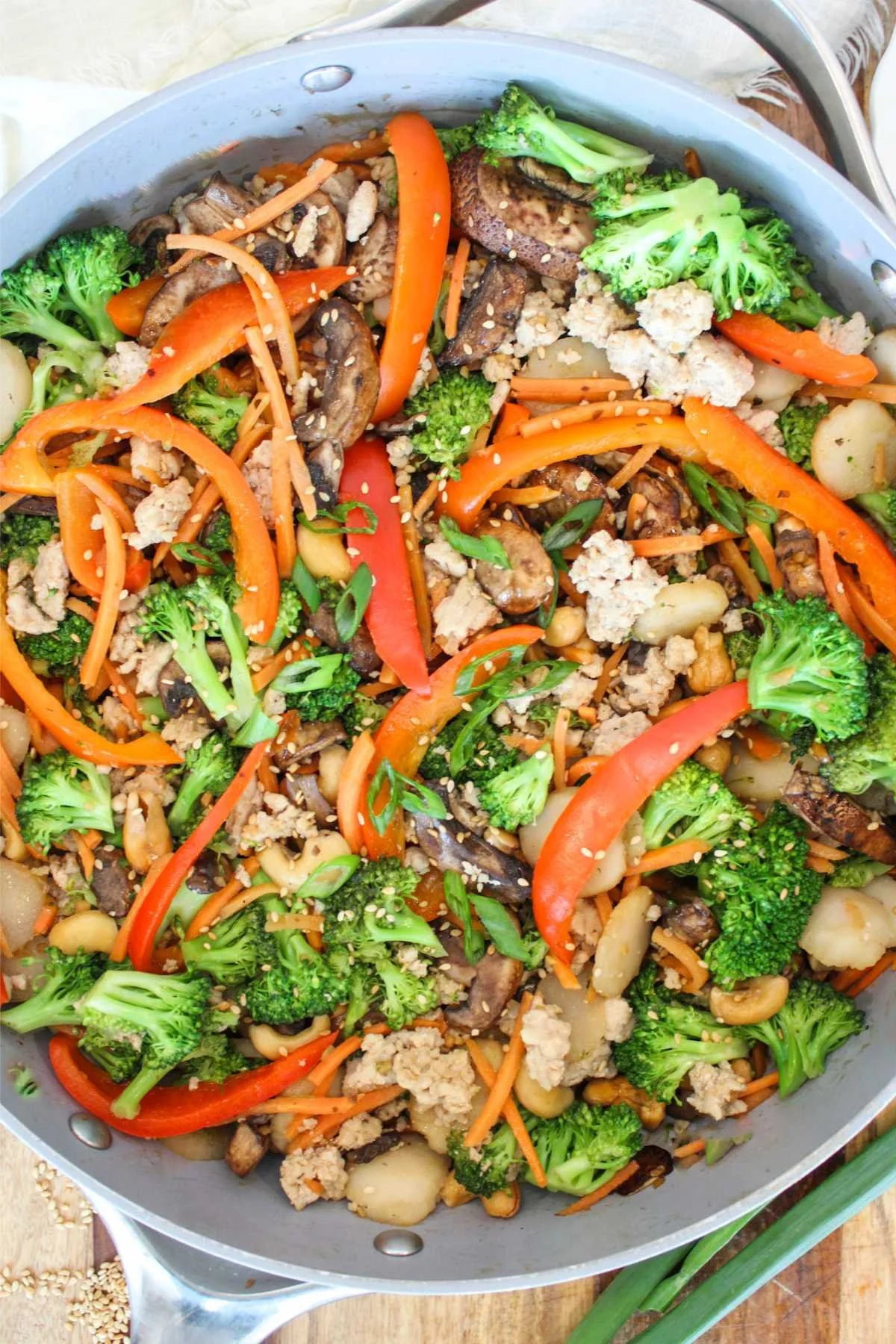 large pan with stir fry vegetables and cooked ground chicken.